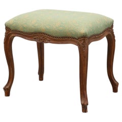 Louis XV stool with carved floral apron and original damask upholstery, France