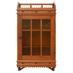 Art Deco oak wall cabinet with amber glazed door, Belgium ca. 1925