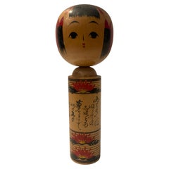 Vintage Japanese Kokeshi Doll with Chrysanthemum Motif and Calligraphy