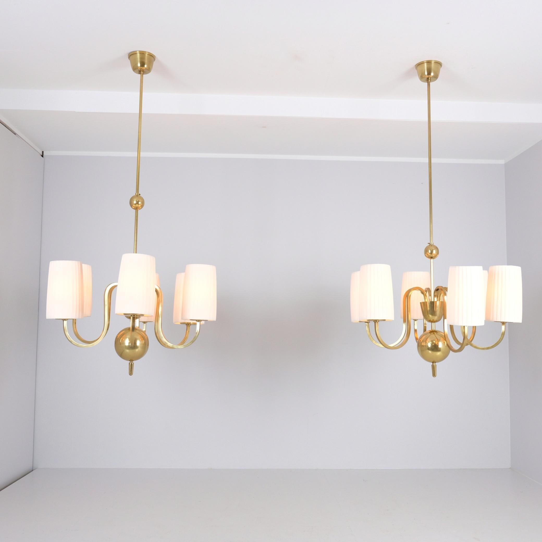 A pair of impressive chandeliers designed by Paavo Tynell and manufactured by Taito Oy in Finland in the 1940s. These chandeliers were made to order for the Workers' House Restaurant of the Turku Workers' Association, and this particular pair was