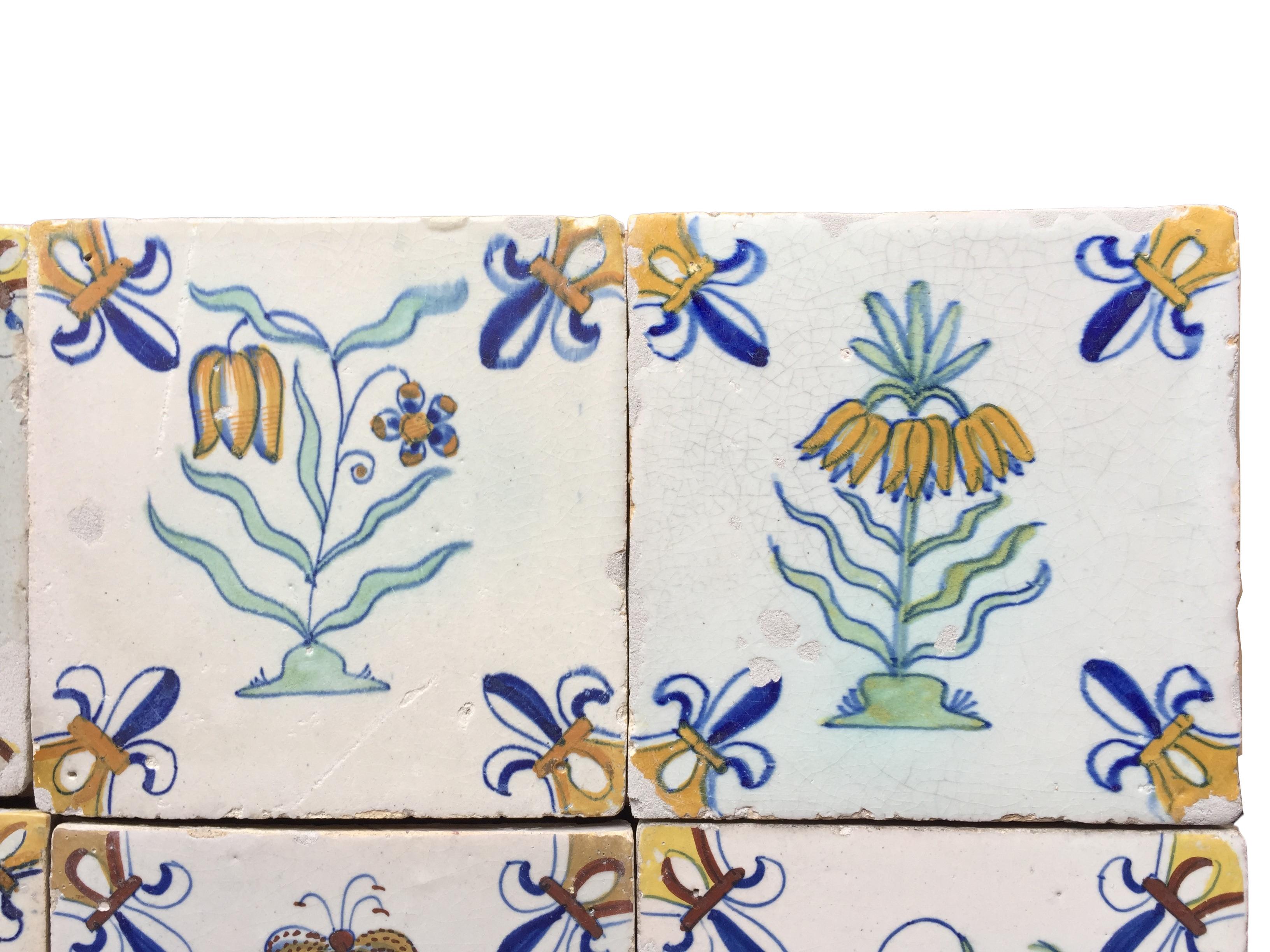 Glazed A set of 12 polychrome Dutch Delft tiles with flowers For Sale
