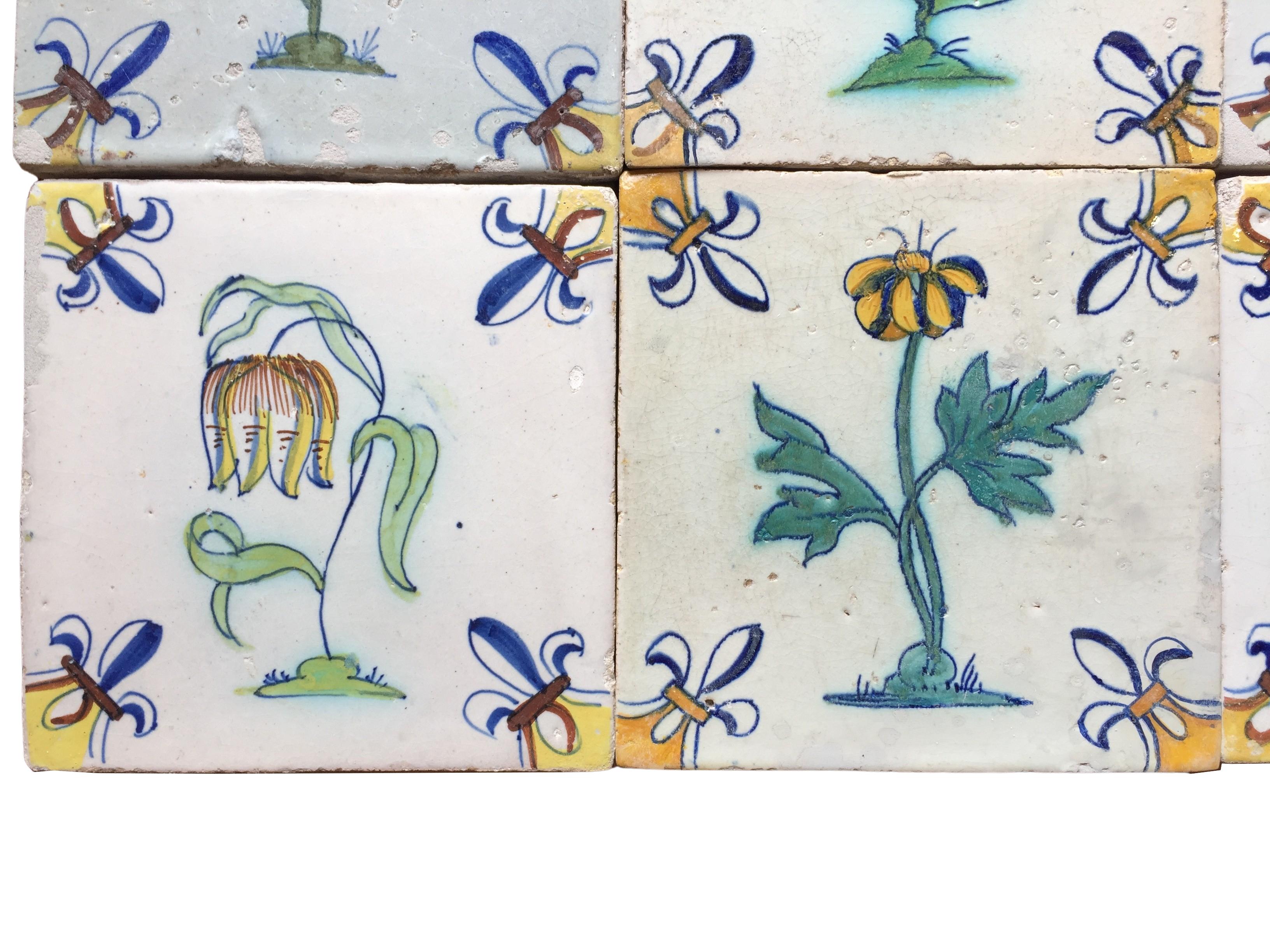 Ceramic A set of 12 polychrome Dutch Delft tiles with flowers For Sale
