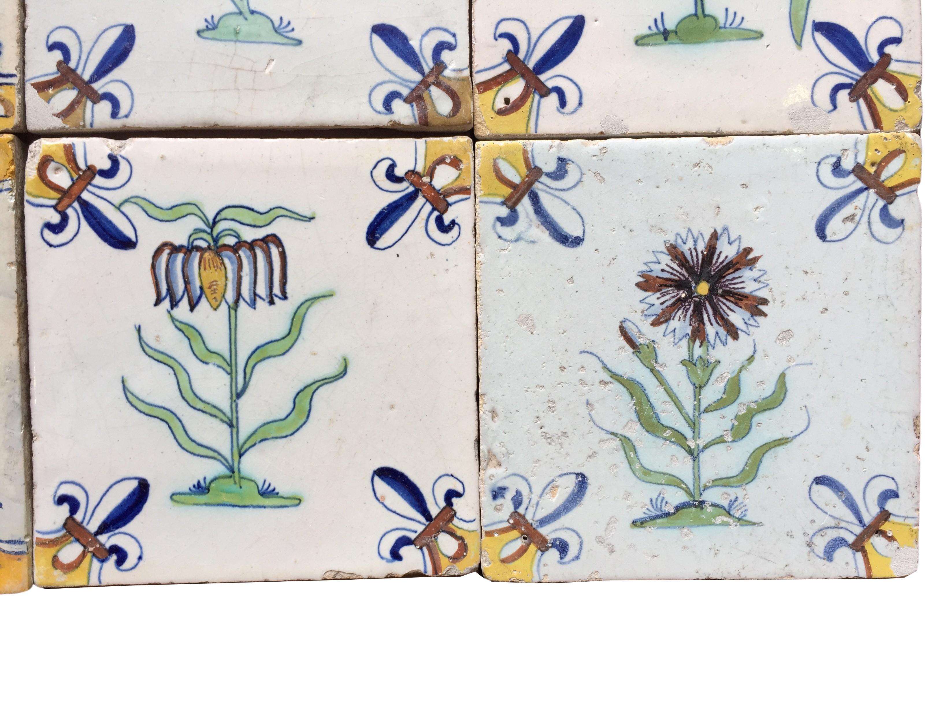 A set of 12 polychrome Dutch Delft tiles with flowers For Sale 1