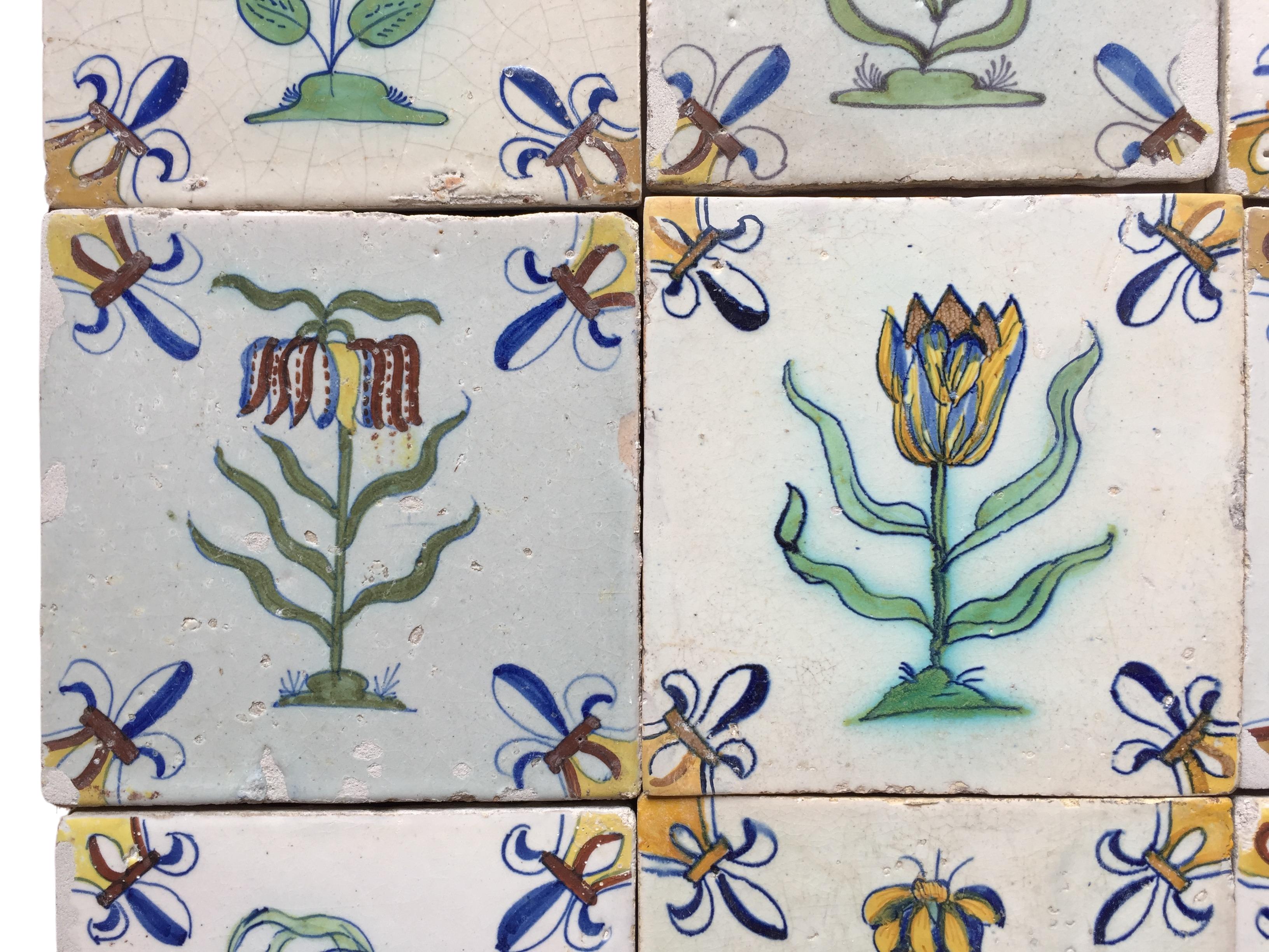 A set of 12 polychrome Dutch Delft tiles with flowers In Good Condition For Sale In AMSTERDAM, NH