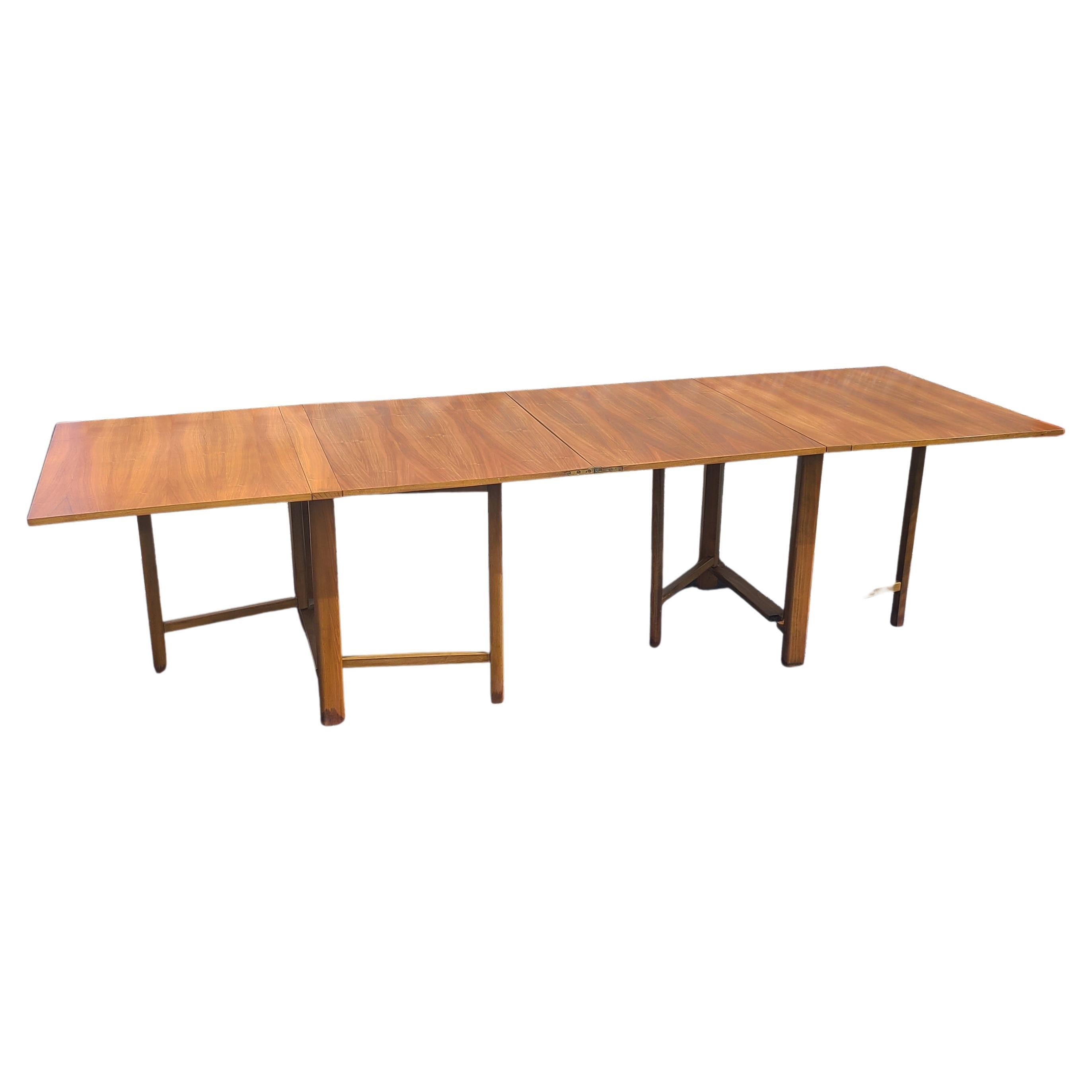Please message us for a cost effective shipping quote to your location.

Mid Century Modern Folding Dining Table. Nice optional features of small dining to large seating capacity. Walnut book matched veneer surface. Beechwood legs.