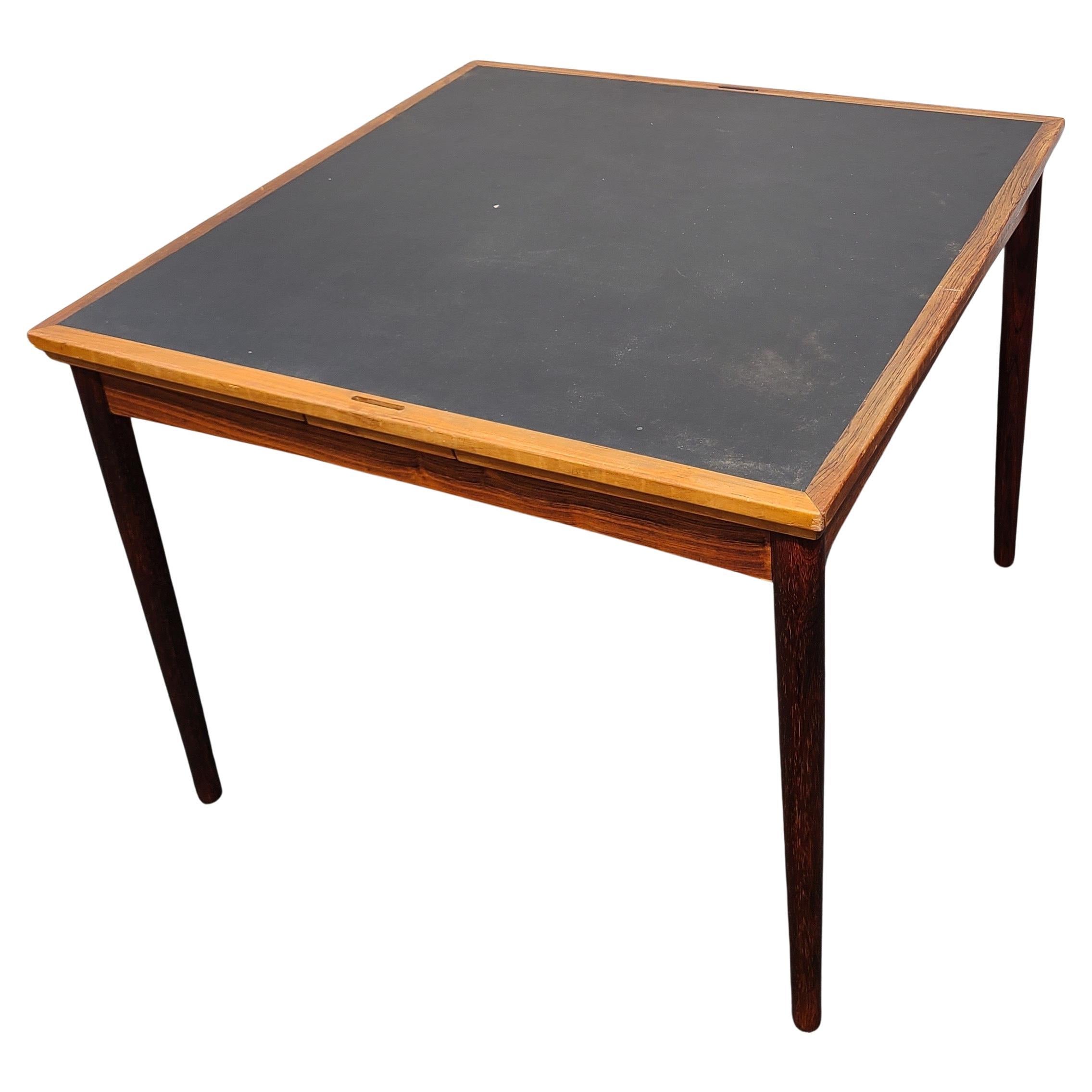 Please message us for a cost effective shipping quote to your location.

Danish Rosewood and Leather Dining Table and Game Table.

Top flips manually. Extensions are stowed under top.

Designed by Carlo Jensen for Poul Hundevad.

Circa 1960. Side