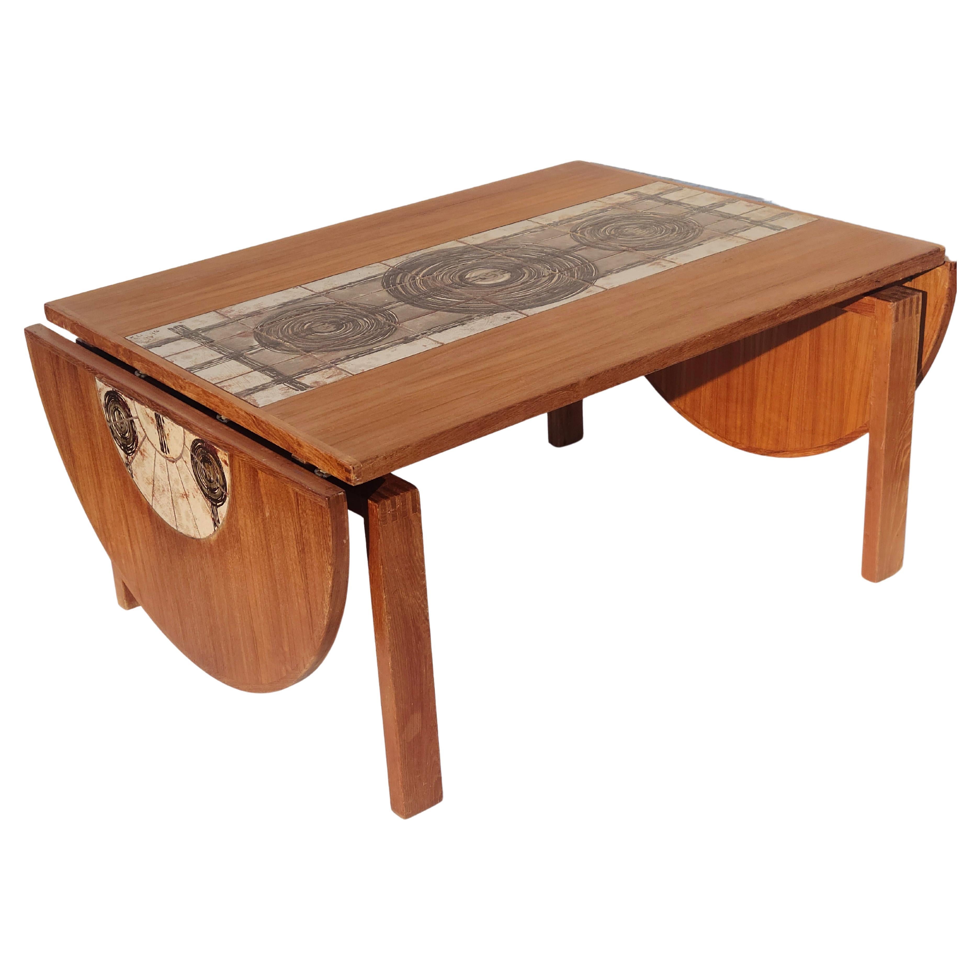 Mid Century Modern Drop Leaf Dining Table.
Branded: A M Made in Denmark
Ceramic Tiles inlaid at top say; Ox Art '73
Teak and Wenge construction.

Please check out our other items for a set of 6 Danish Teak Dining chairs to match.