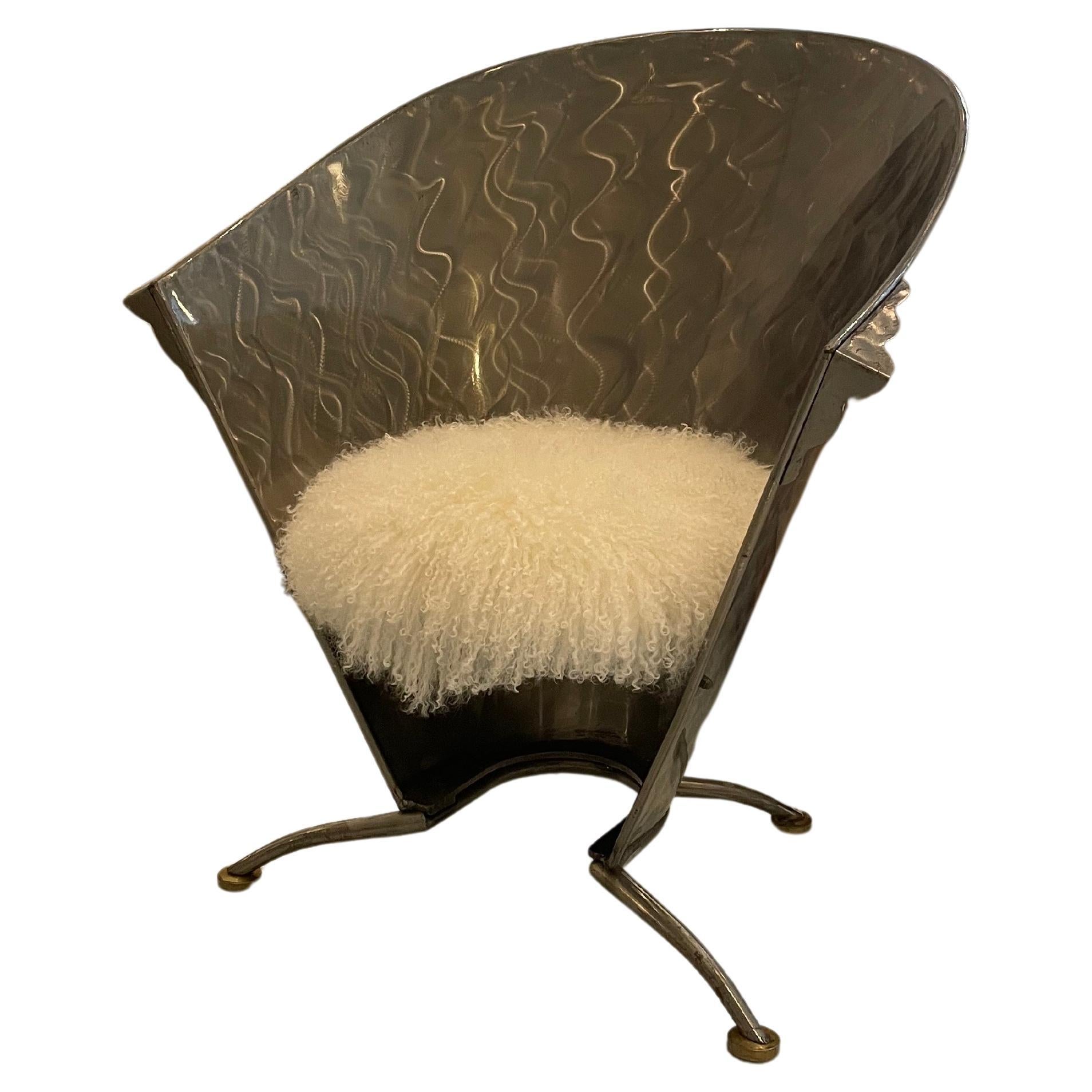 Made from Steel on brass feet in the 1980s – 90s. The seat has been upholstered in White Mongolian Sheepskin.