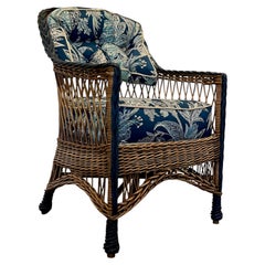 An Antique Hand Woven Natural Finish Bar Harbor Style Arm Chair With Blue Trim