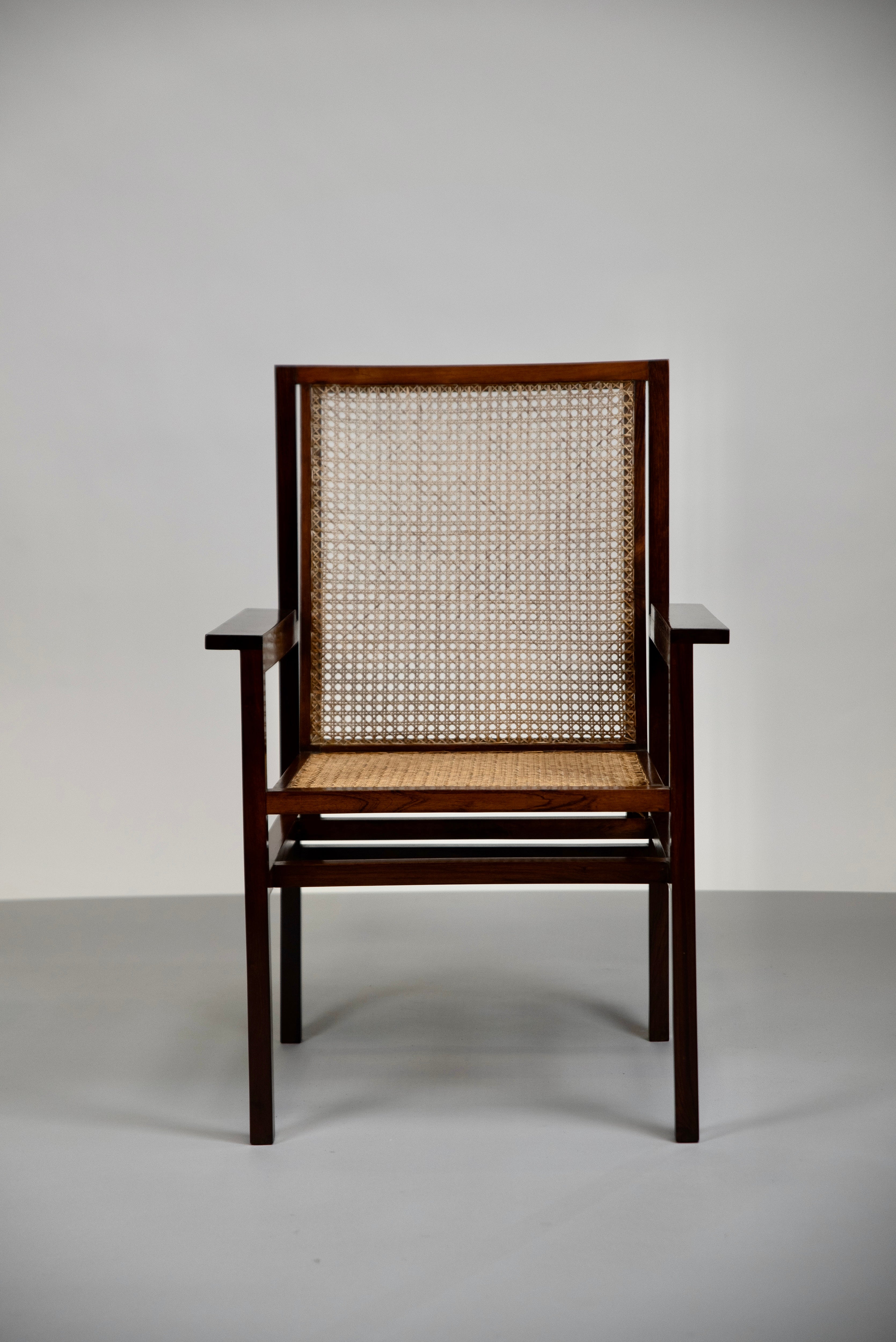This armchair was designed around 1947 by Joaquim Tenreiro, the Brazilian master designer. It has typical Tenreiro characteristics. First of all, the use of this rare wood and cane, a combination that Tenreiro used very often not only because they