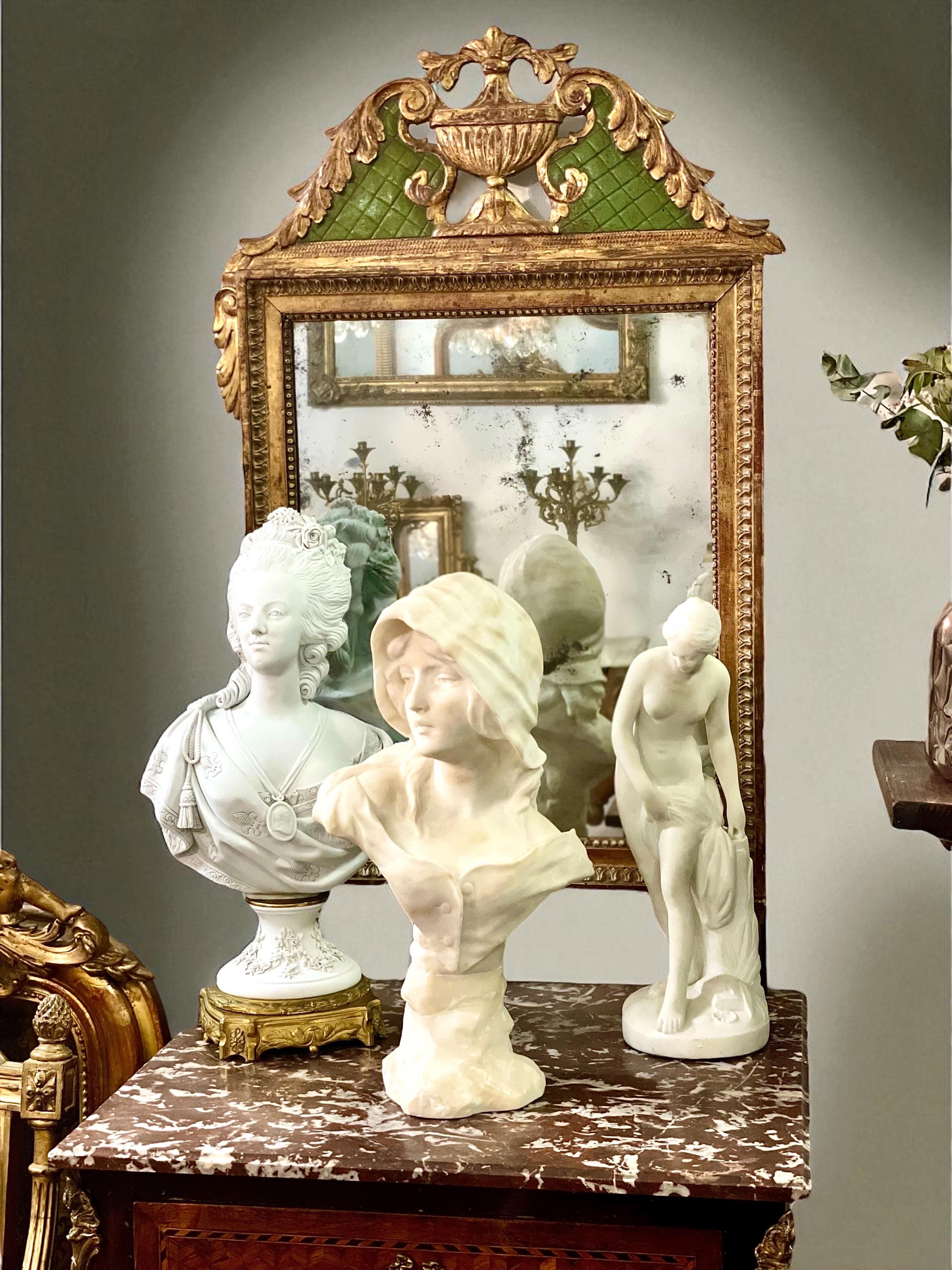 Introducing a mesmerizing alabaster bust by renowned sculptor Georges Morin (1874-1950). 

This exquisite piece, dating from the end of 19th century, showcases a young woman in a delicately buttoned bustier, revealing a graceful neckline and long,