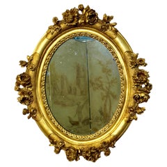 Antique Mirror ovale in legno dorato Luigi XVI con intaglio floreale