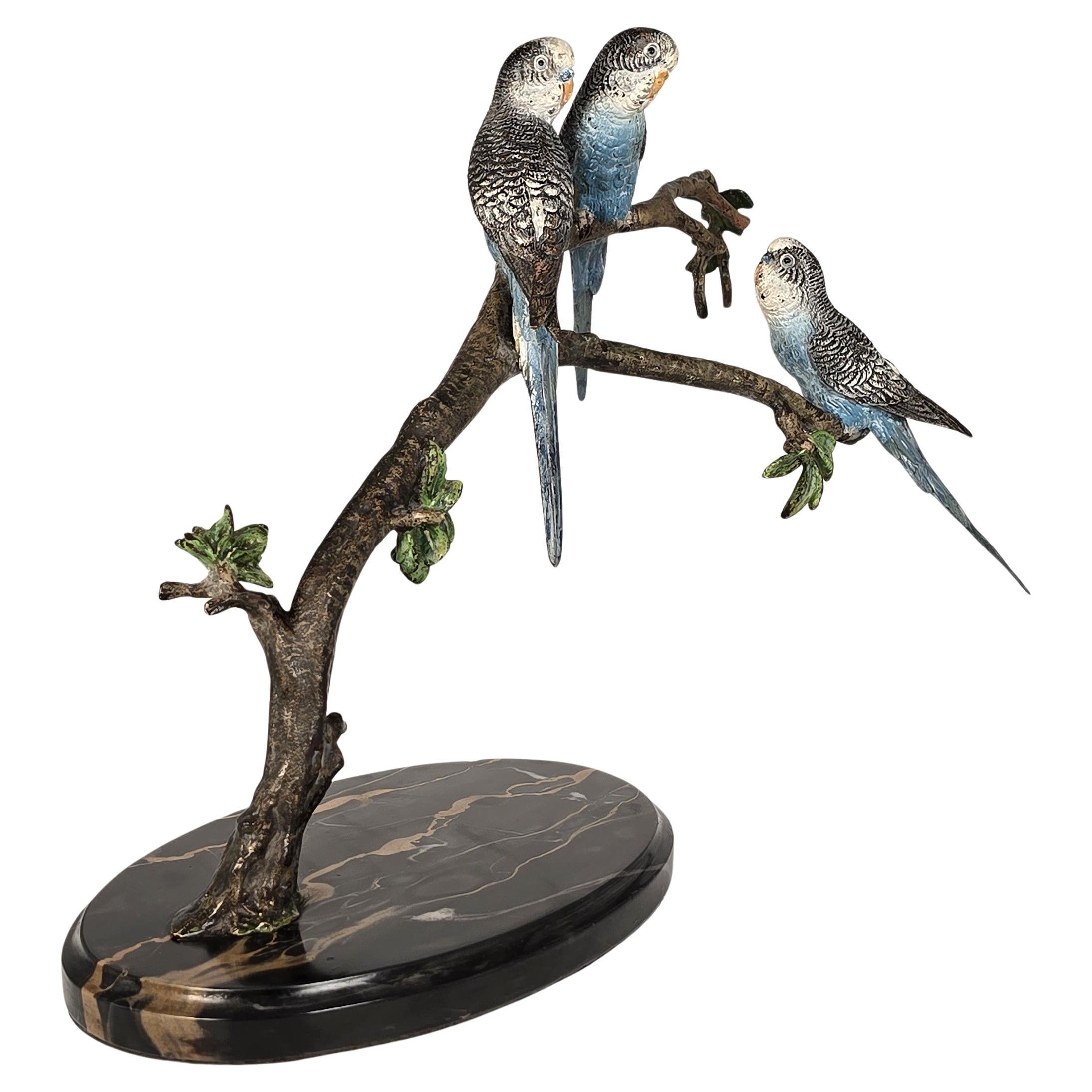 Budgerigars, Austrian bronze cold painted, three sat on a branch, circa 1930