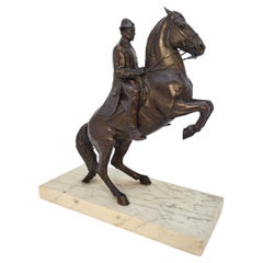Mid 20th C equestrian bronze study showing a rider and horse