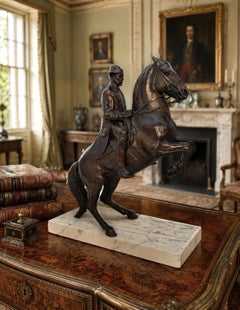 Mid 20th C equestrian bronze study showing a rider and horse