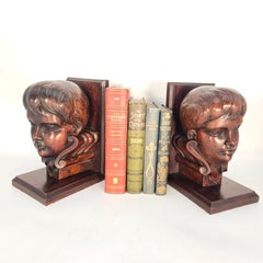 A pair of carved library bookends in the form of Choirboys, English circa 1880