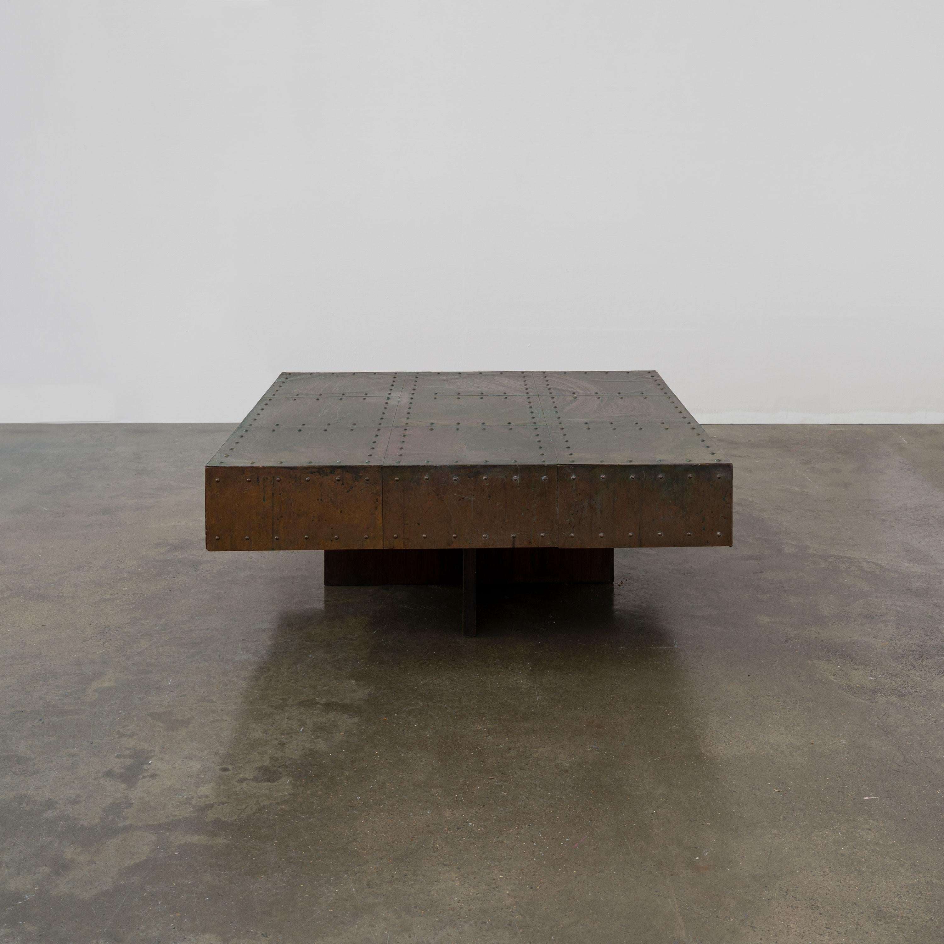A very good, unattributed, artisan made coffee table made from a square, riveted copper panelled top mounted on a mahogany cruciate base. The top has a wonderful natural patina of browns, greens and blues. 

Dimensions (cm, approx):
Height: