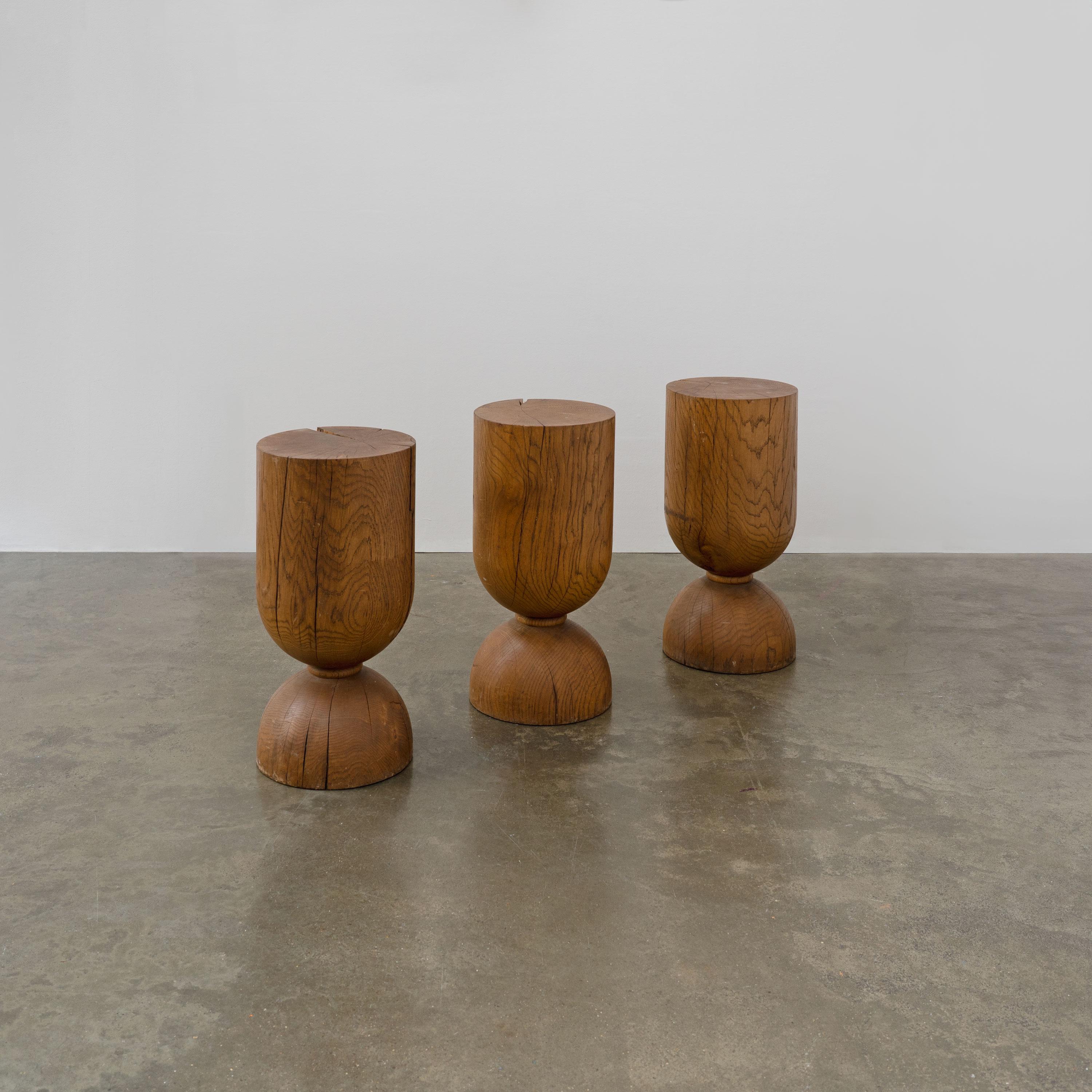 Vintage sculptural stools / side tables made from solid oak.

Priced per stool.

Dimensions (cm, approx):
Height: 60
Diameter: 29

Condition: In fair condition with notable stable splits to the wood and minor scuffs, as pictured. 