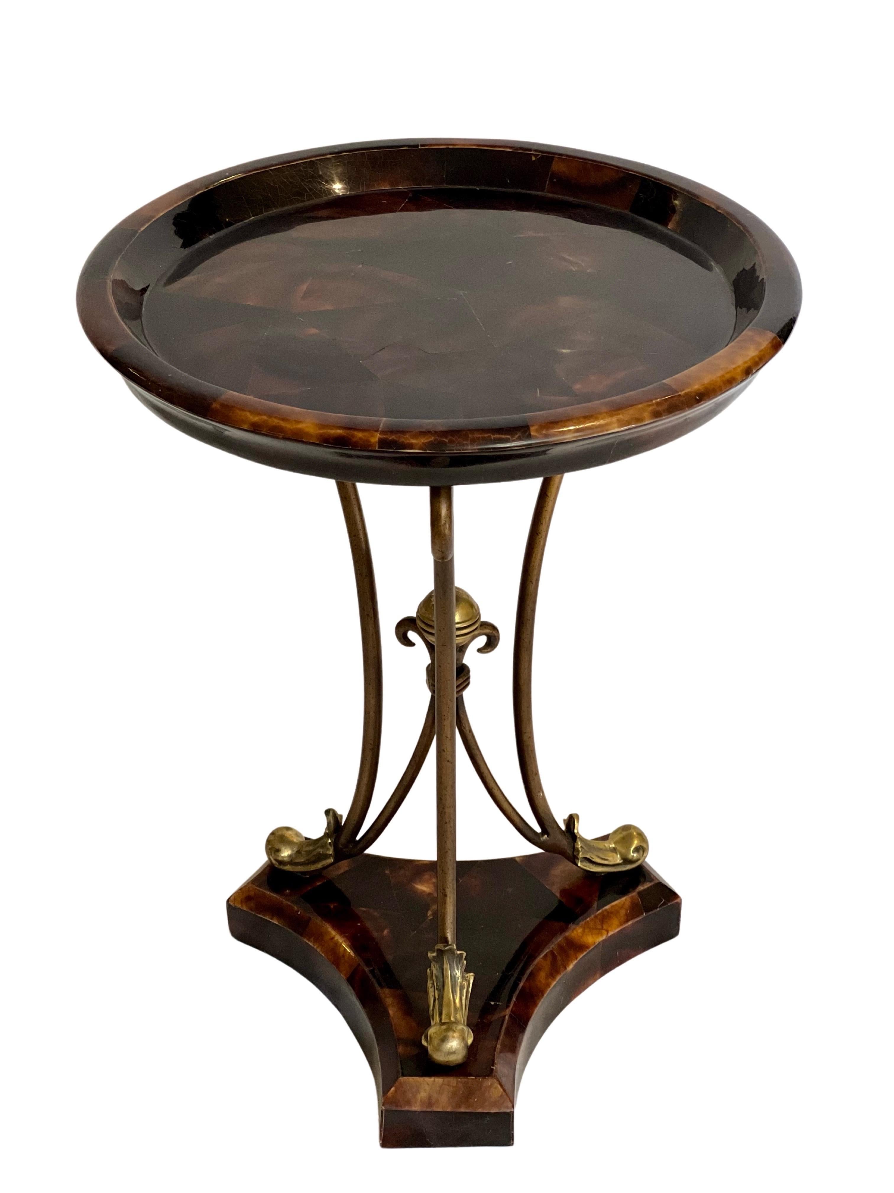 1970's Maitland Smith marquetry inlaid occasional table with a chunky geometric glossy horn veneer. Bronzed iron and gold leaf scrolled stem.
