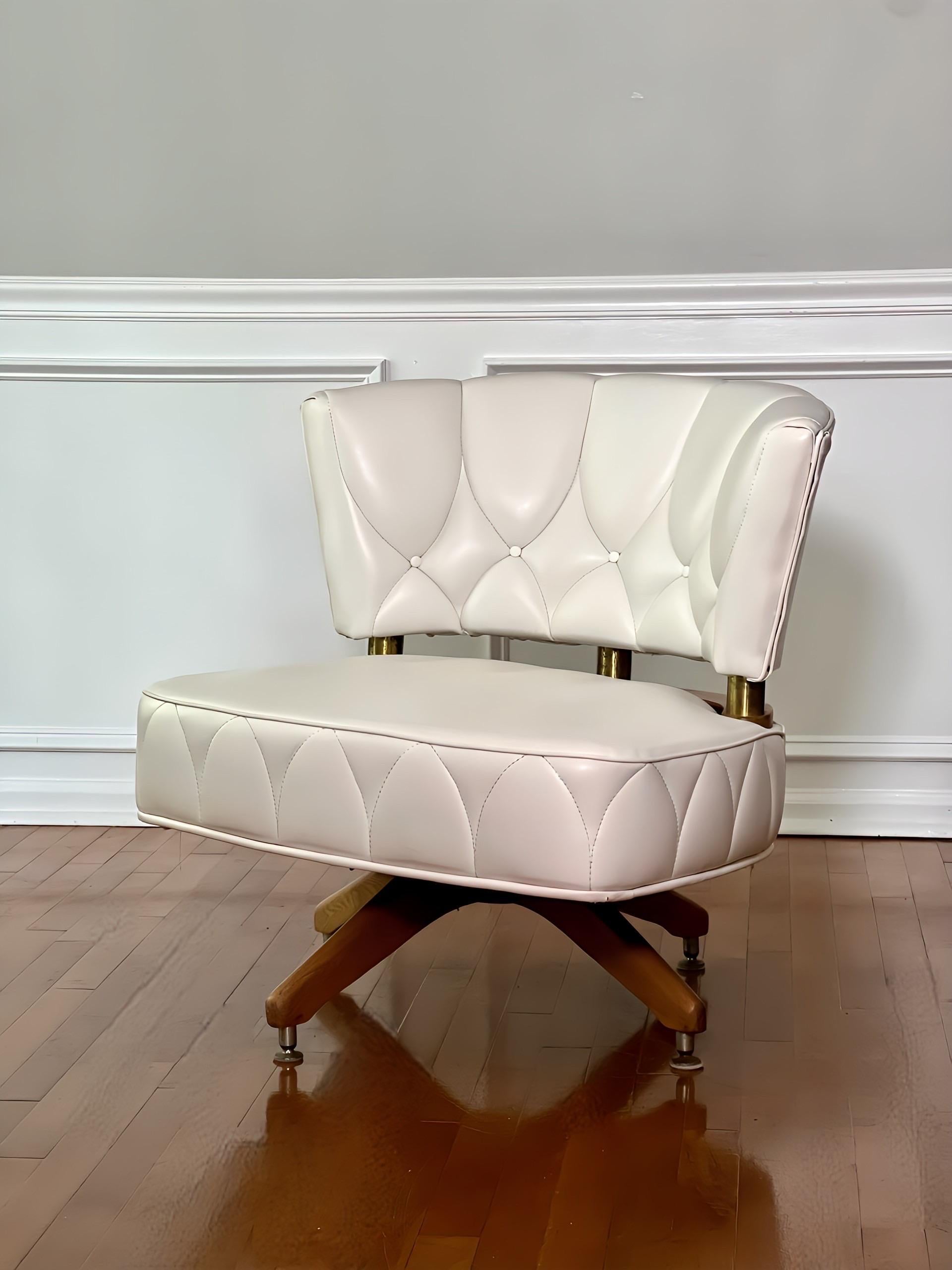 Vintage swivel side chair by Kroehler, 1962.  Chic chair upholstered in a vibrant, creamy shade of white faux leather with stitching pattern detail.  A generous and comfortable seat swivels 360 degrees on a hearty four-legged wood base.  The seat