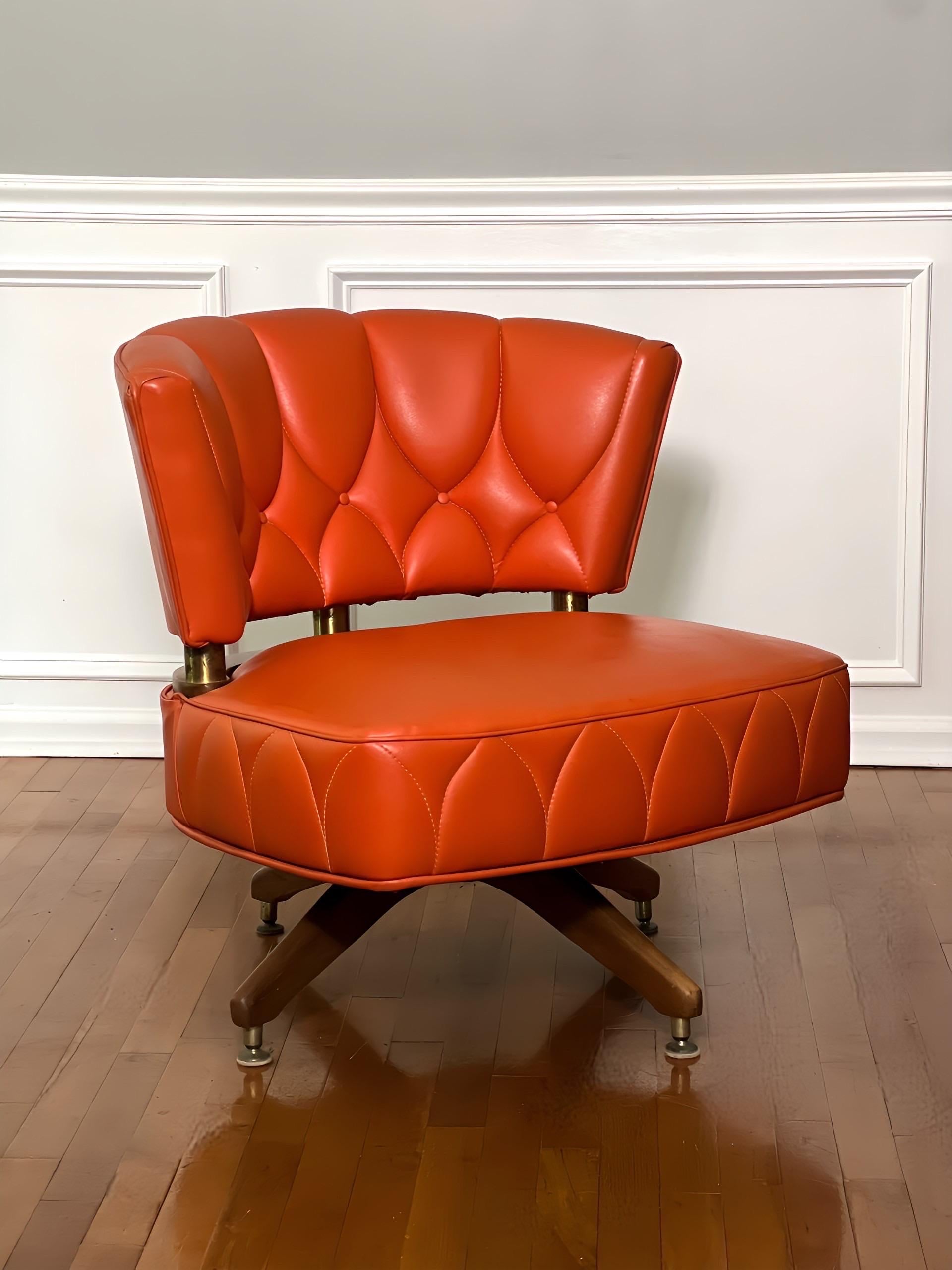 Vintage swivel side chair by Kroehler, 1962.  Chic chair upholstered in a vibrant shade of tangerine orange faux leather with unique stitching pattern detail.  A generous and comfortable seat swivels smoothly 360 degrees on a hearty four-legged