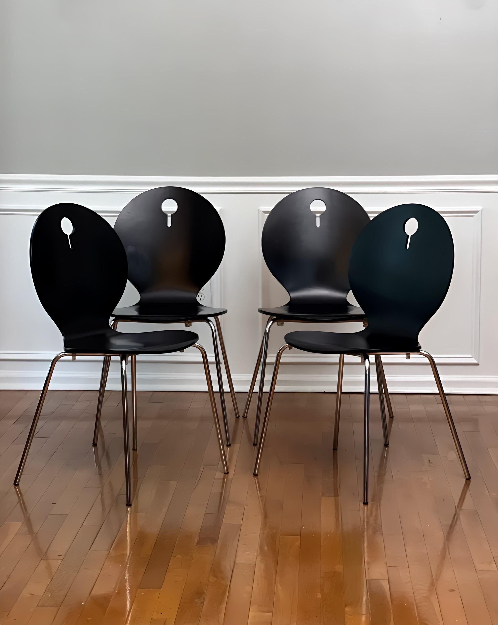Set of 4 Italian modern stackable bentwood dining or side chairs by Calligaris, Italy.  These versatile chairs are comfortable with an ergonomic, molded form in a satin finish black lacquer. They feature a clean design with a decorative cutout in