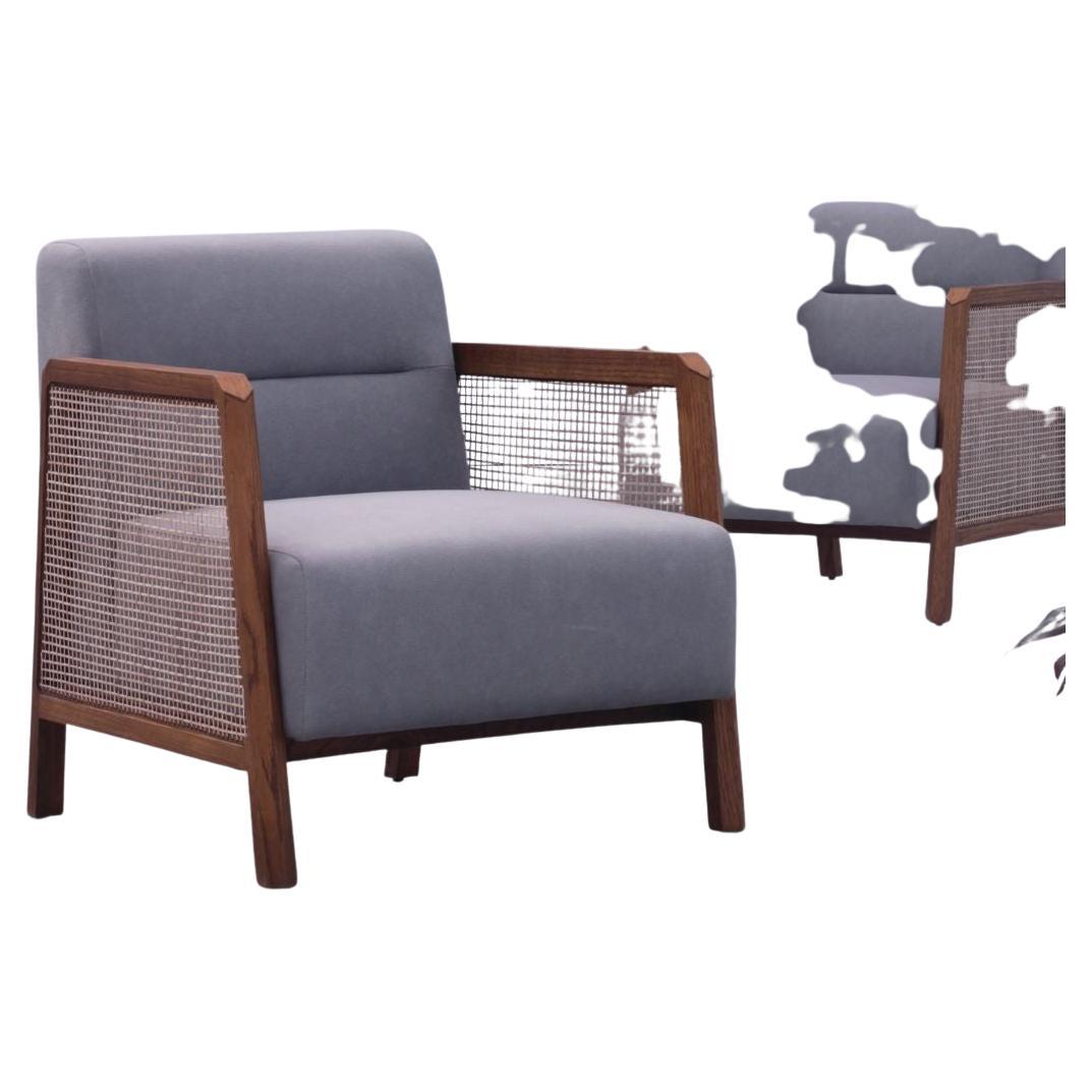 The Oasis solid wood Lounge chair with armrests is the perfect addition to any home. With its airy and minimal aesthetic, the Lounge chair is perfect for Boho, minimal, and a variety of other interior styles. The handwoven cane sides, tactile