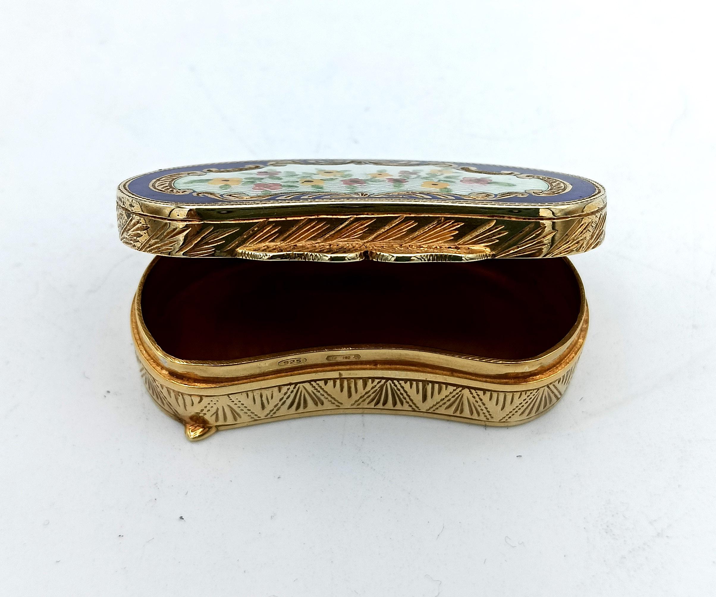 Shaped pill box in 925/1000 sterling silver gold plated with translucent fired enamels on guilloché and hand-painted floral miniature, with fine hand engravings. Viennese Art Nouveau style, second half of the 19th century. Measurements cm. 2.5 x 5