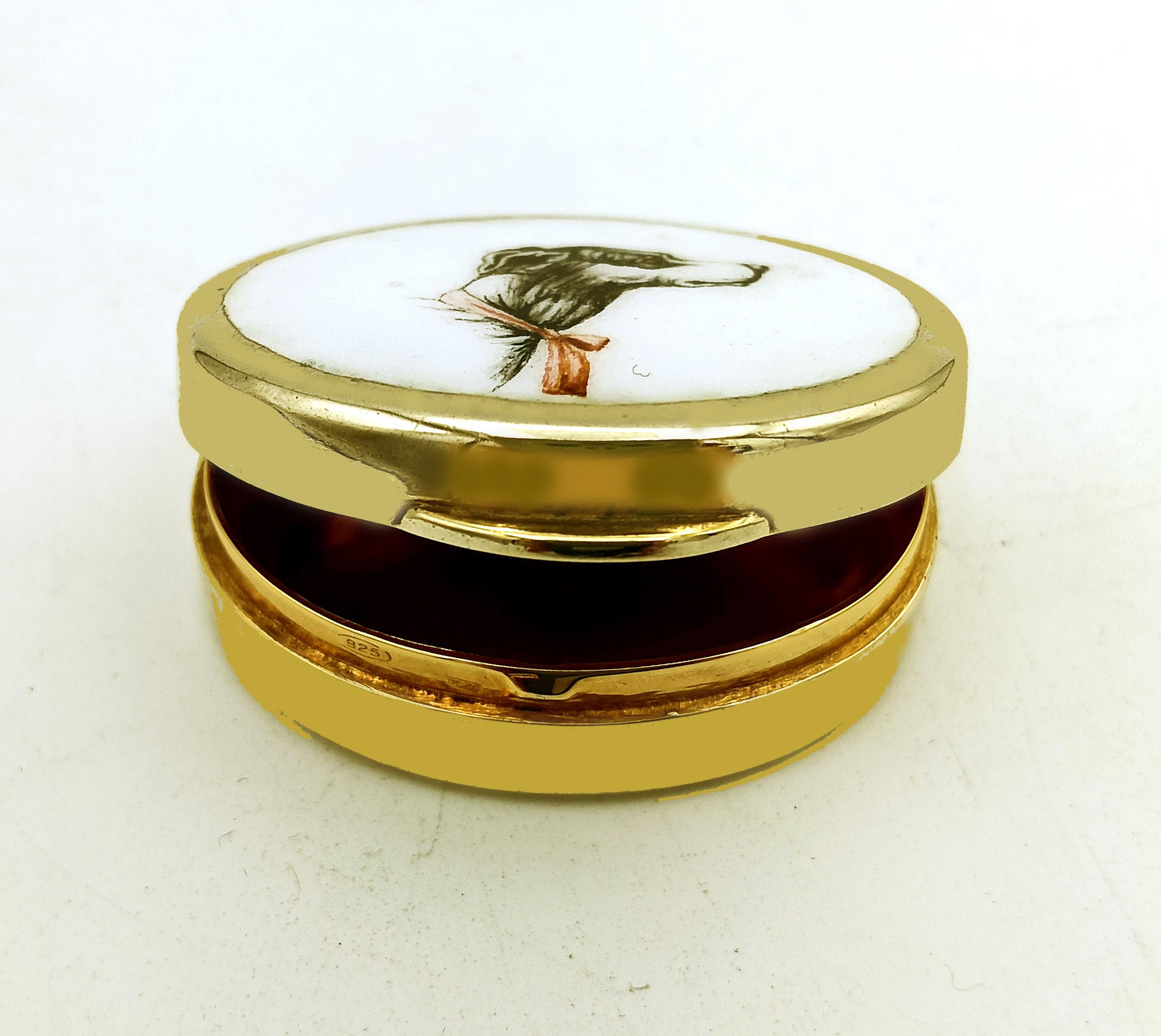Oval pill box in 925/1000 sterling silver gold plated with a fired enamelled miniature hand painted by the painter Romano Buccioni of a greyhound dog head on a white background. English Art Nouveau style. Size cm. 3 x 4 height cm. 1.3. Weight gr.
