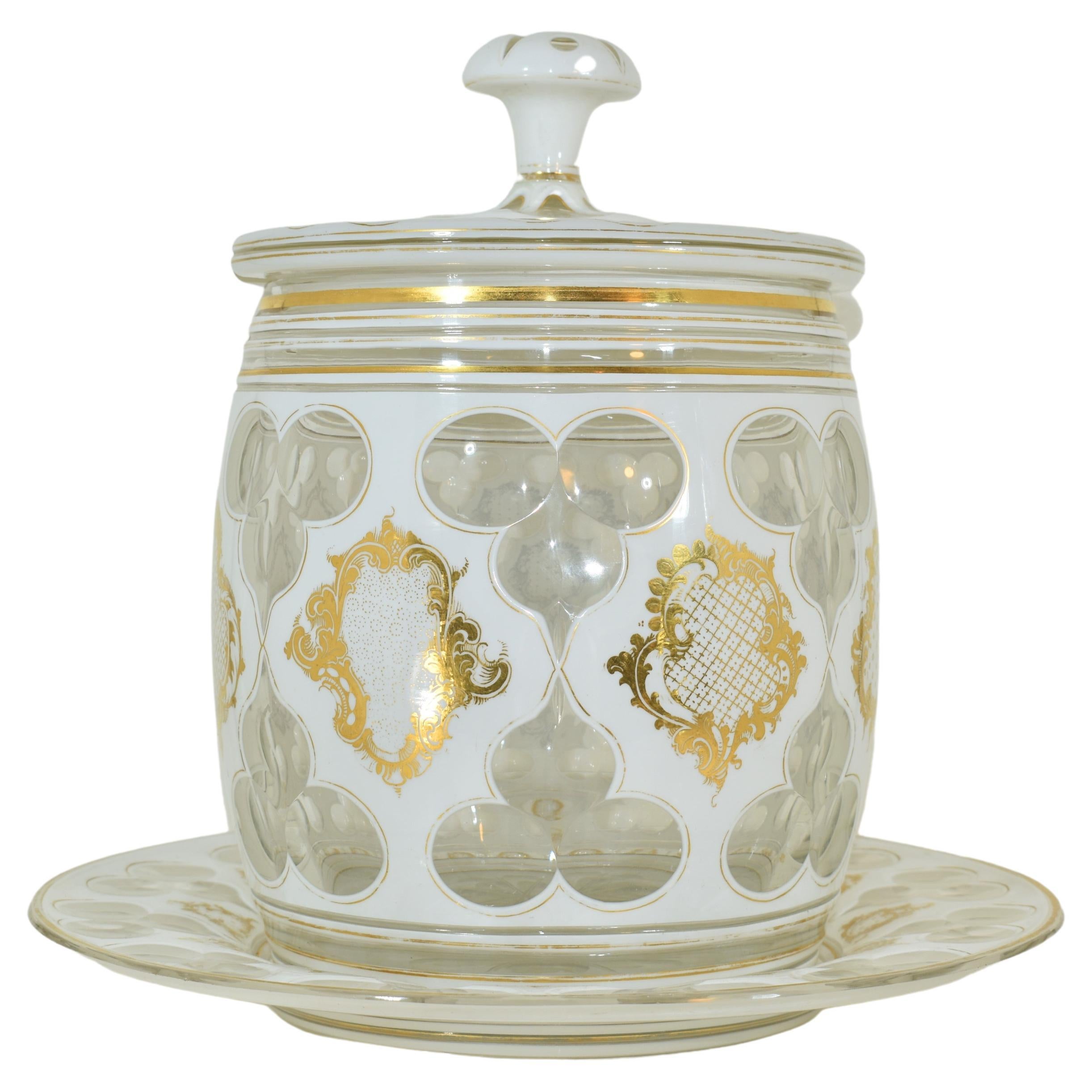 Made by the Bohemian Art Glass manufacturers of the 19th Century, transparent crystal with white opaline glass overlay, fabulously hand-cut in beautiful patterns, the circular body is finely hand-painted with gold scrollwork decoration on the milky