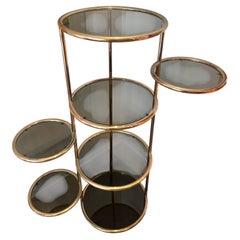 A vintage Milo Baughman style 7 tiered brass & smoked glass articulating etagere