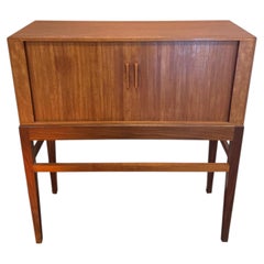 A tall mid century modern Danish cocktail cabinet with tambour doors, circa 1960