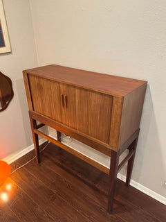 A tall mid century modern Danish cocktail cabinet with tambour doors, circa 1960