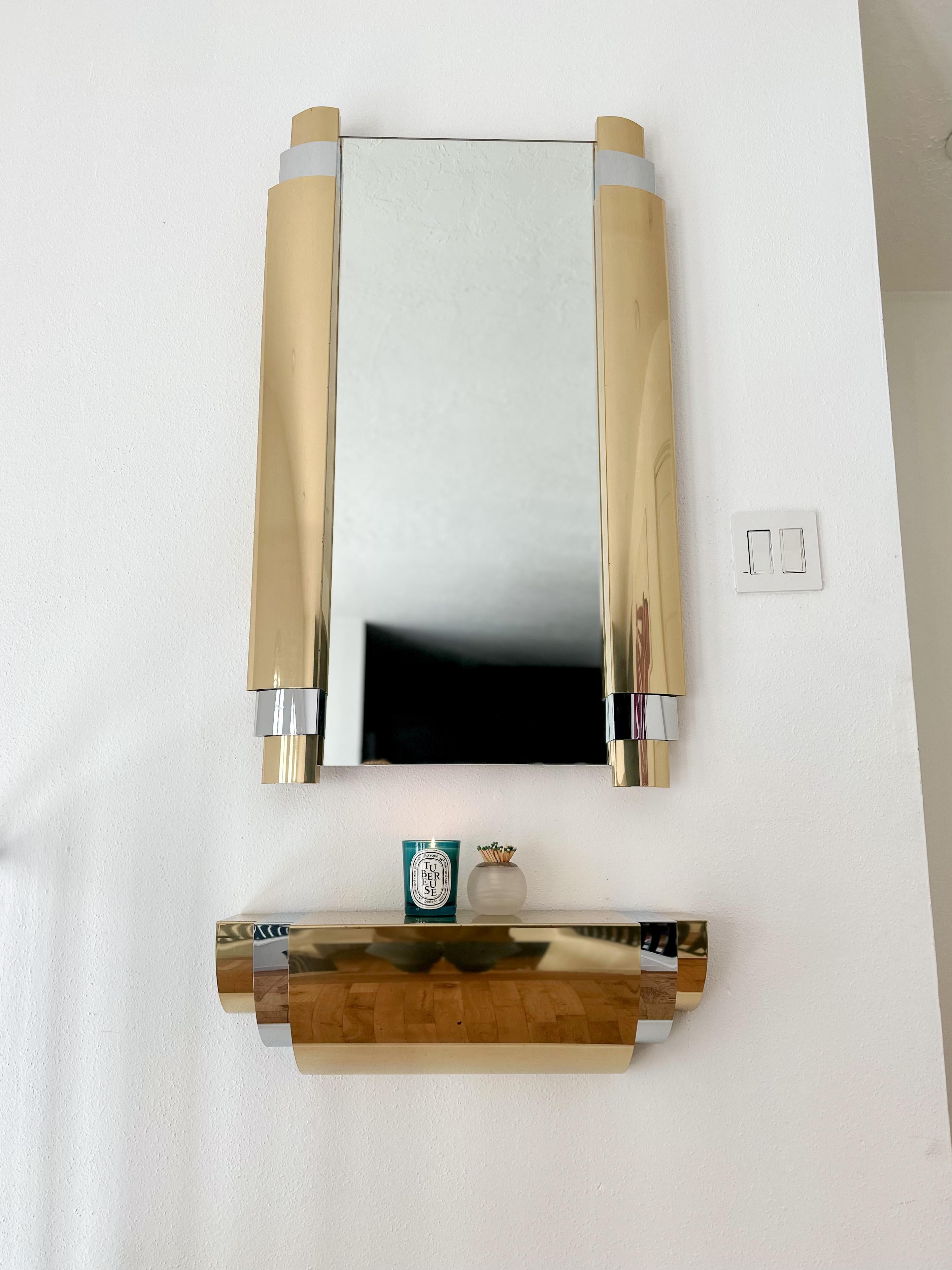 Rare Art Deco style brass and chrome mirror and shelf set designed by Curtis Jeré for Artisan House, c.1985. Wall-mounted and slender in profile, you don't need much wall space to give this set the perfect home. Super sleek and ultra-glam, this pair