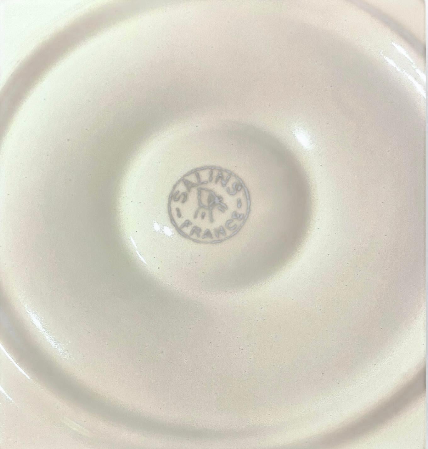 A set of four Antique French oyster plates by the noted French maker Salins. Each plate with six Wells for your oysters and a center well for your lemon.