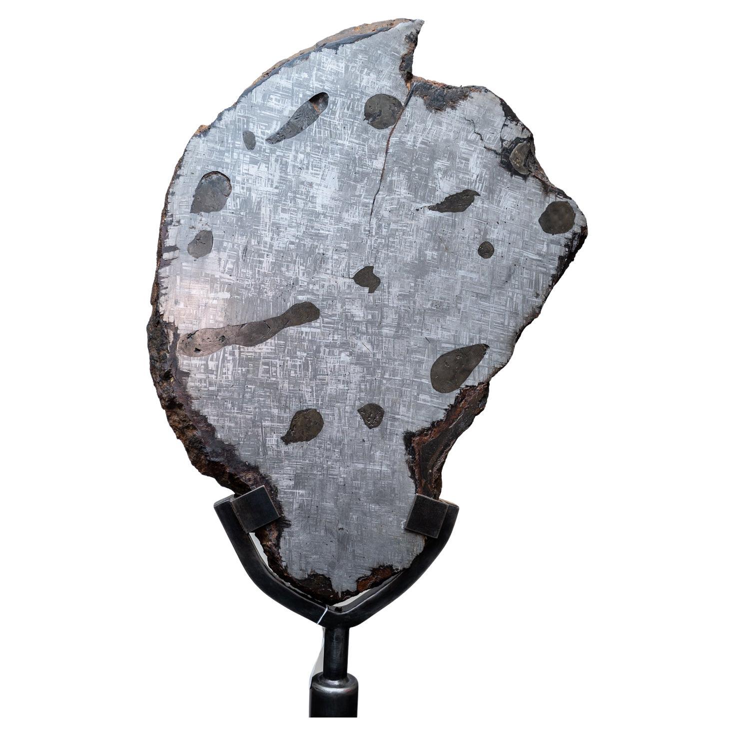 Truly a museum quality piece, this giant meteorite is a completely solid, natural Muonionalusta Meteorite sliced & polished which boasts its beautiful, metallic Widmanstätten pattern. The meteorite alone weighs 86.6 pounds and measures 17.25