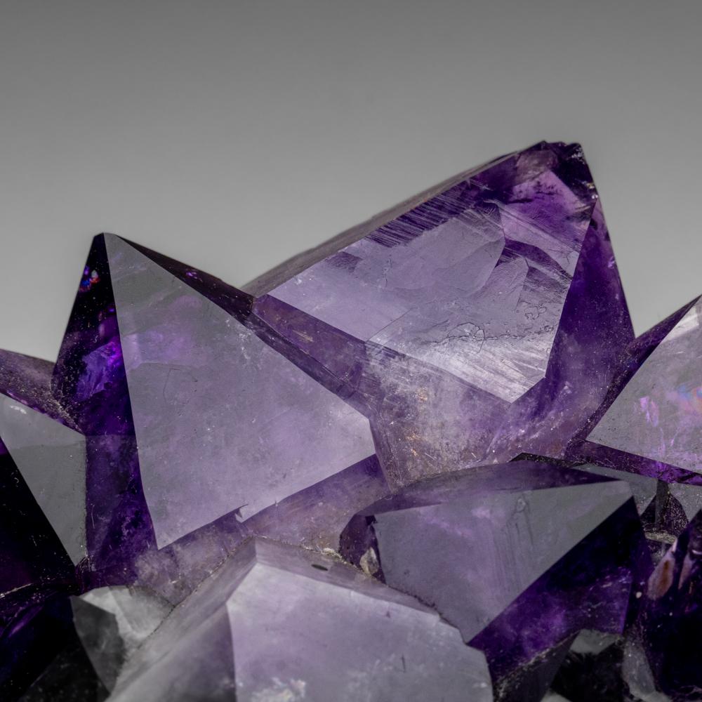 This top quality natural amethyst cluster from Brazil features lustrous, fully-terminated crystals with highly reflective faces and deep, transparent to translucent grape hues. Amethyst is a powerful crystal used to enhance spiritual awareness and