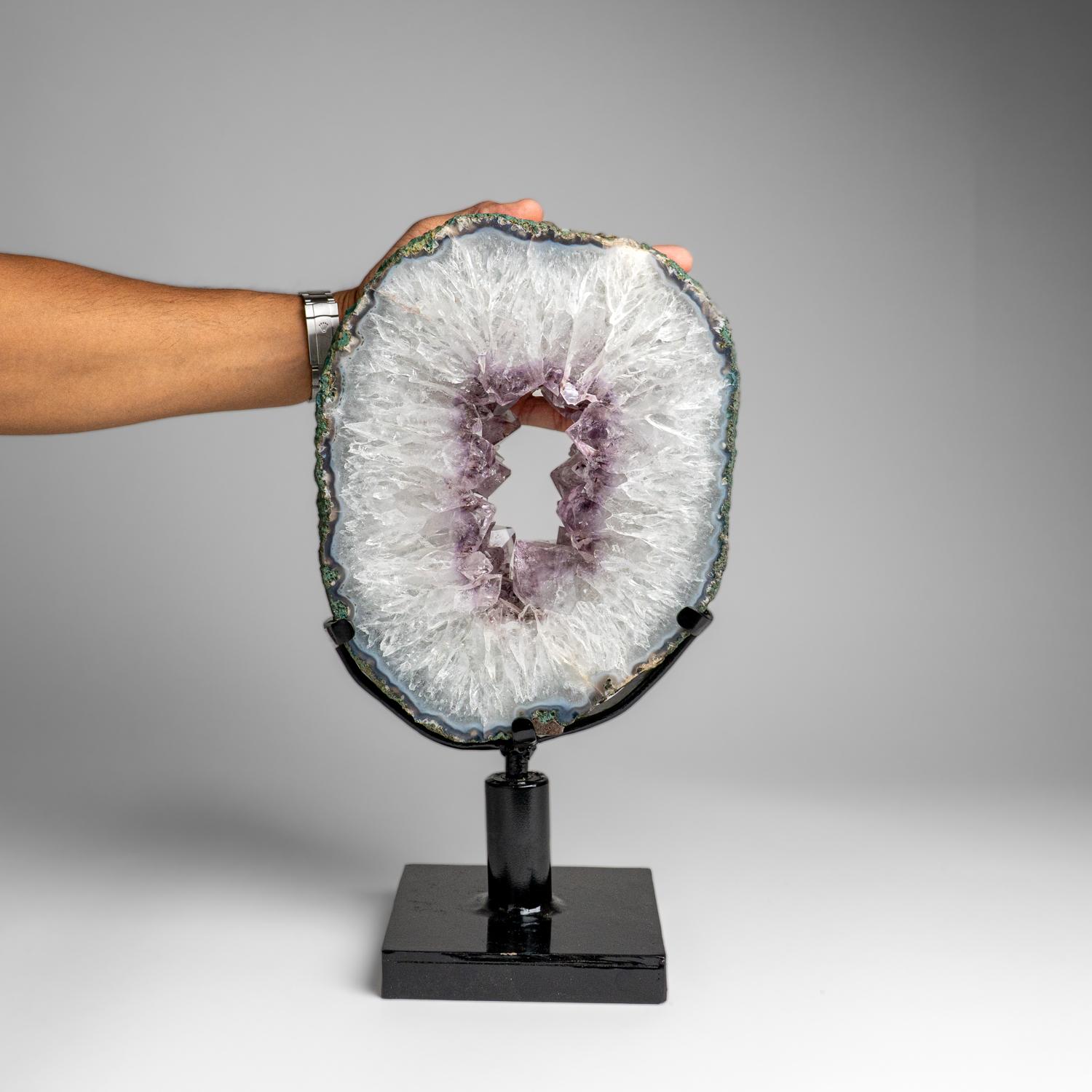 This top museum quality Amethyst Quartz geode slice features naturally formed, lustrous and fully terminated with highly reflective faces and a deep, transparent to translucent hues. This beautiful specimen comes with a metal stand and is perfect