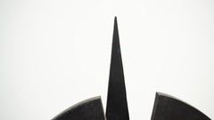 Black brutalist wooden sculpture