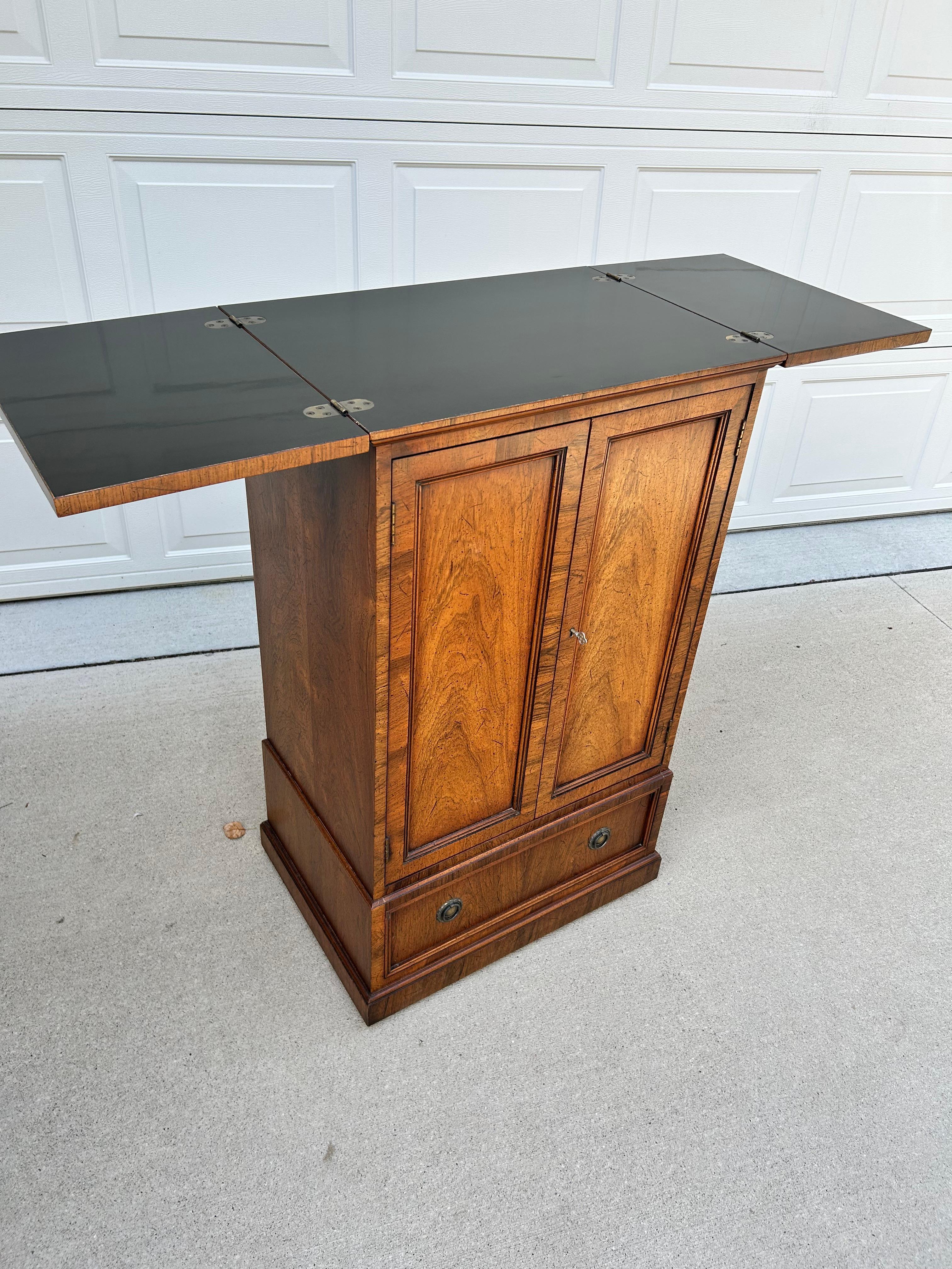 Crafted by Henredon Fine Furniture, this vintage dry bar cabinet exudes sophistication and timeless elegance, making it a statement piece for any discerning collector.  The thoughtfully designed interior includes shelving for bottles and glassware,