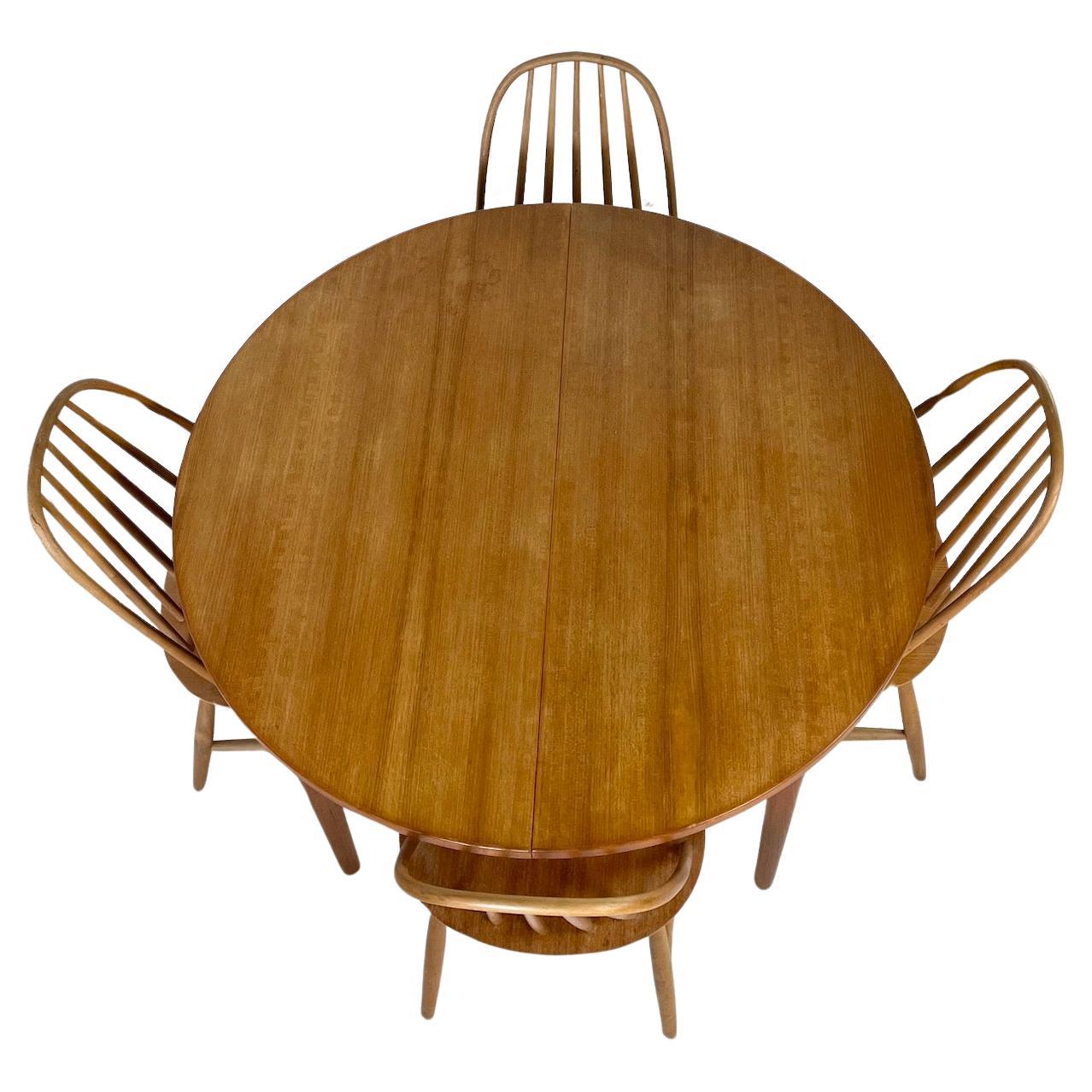 Swedish teak circular dining table extending to an oval with 2 integrated folding leaves
Made in Sweden
Label to underside of table
TROEDS Malta Nils Jonsson
Circa 1950s
Table Circular: Height 73cm Diameter 110cm
Table Oval: Height 73cm Length 140cm