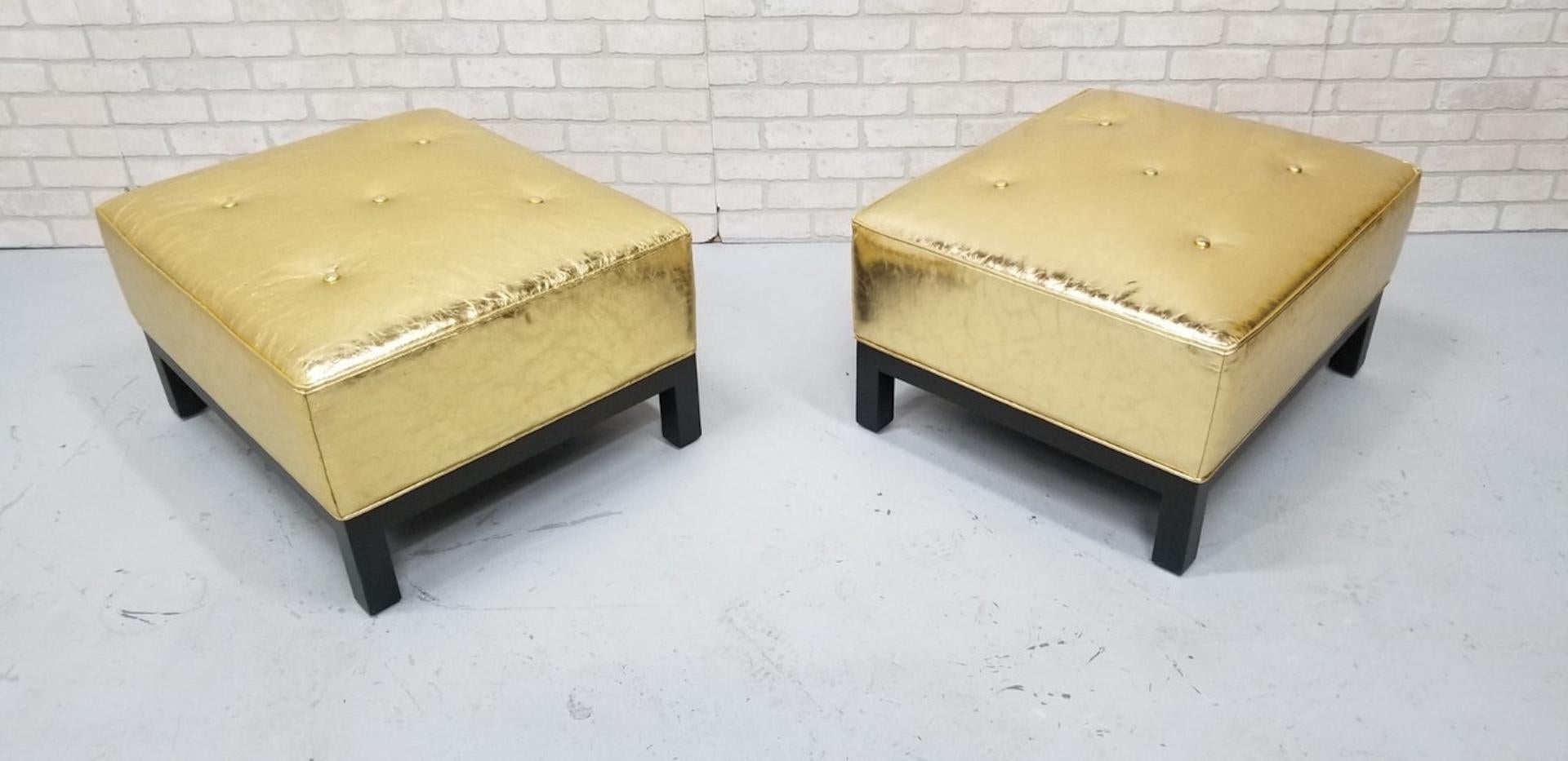 Hollywood Regency Christian Liaigre Style Stools Newly Upholstered in Distressed Gold Leather

This chic pair of Hollywood Regency ottomans have been newly reupholstered in gold leaf leather. The upholstered cushion sits on a java walnut base. These