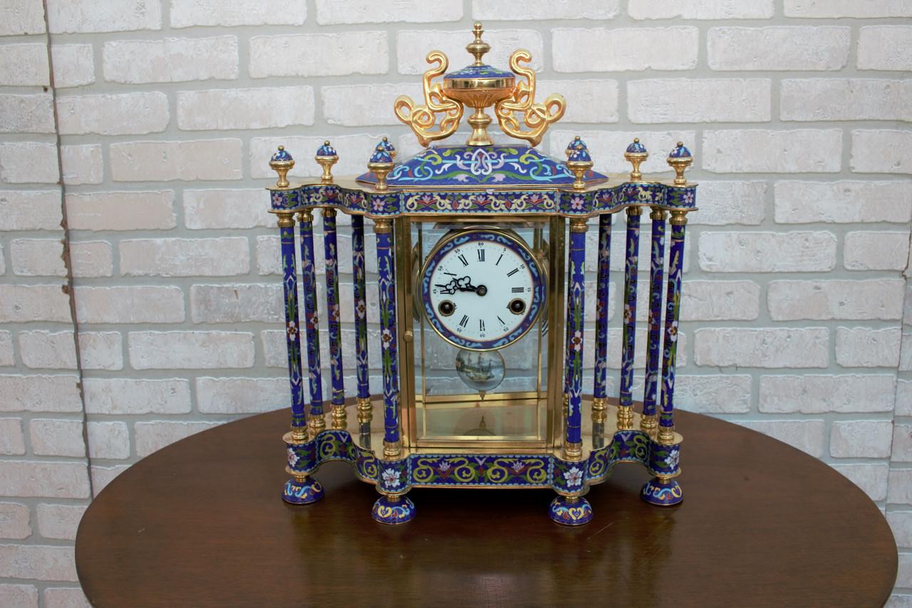 Mid Century Chinese Cloisonné Mantel Clock

Decorate your mantlepiece with this intricately designed cloisonné clock. The clock face is flanked by columns decorated with flowers. The piece is mounted on golden legs and the top of the clock is