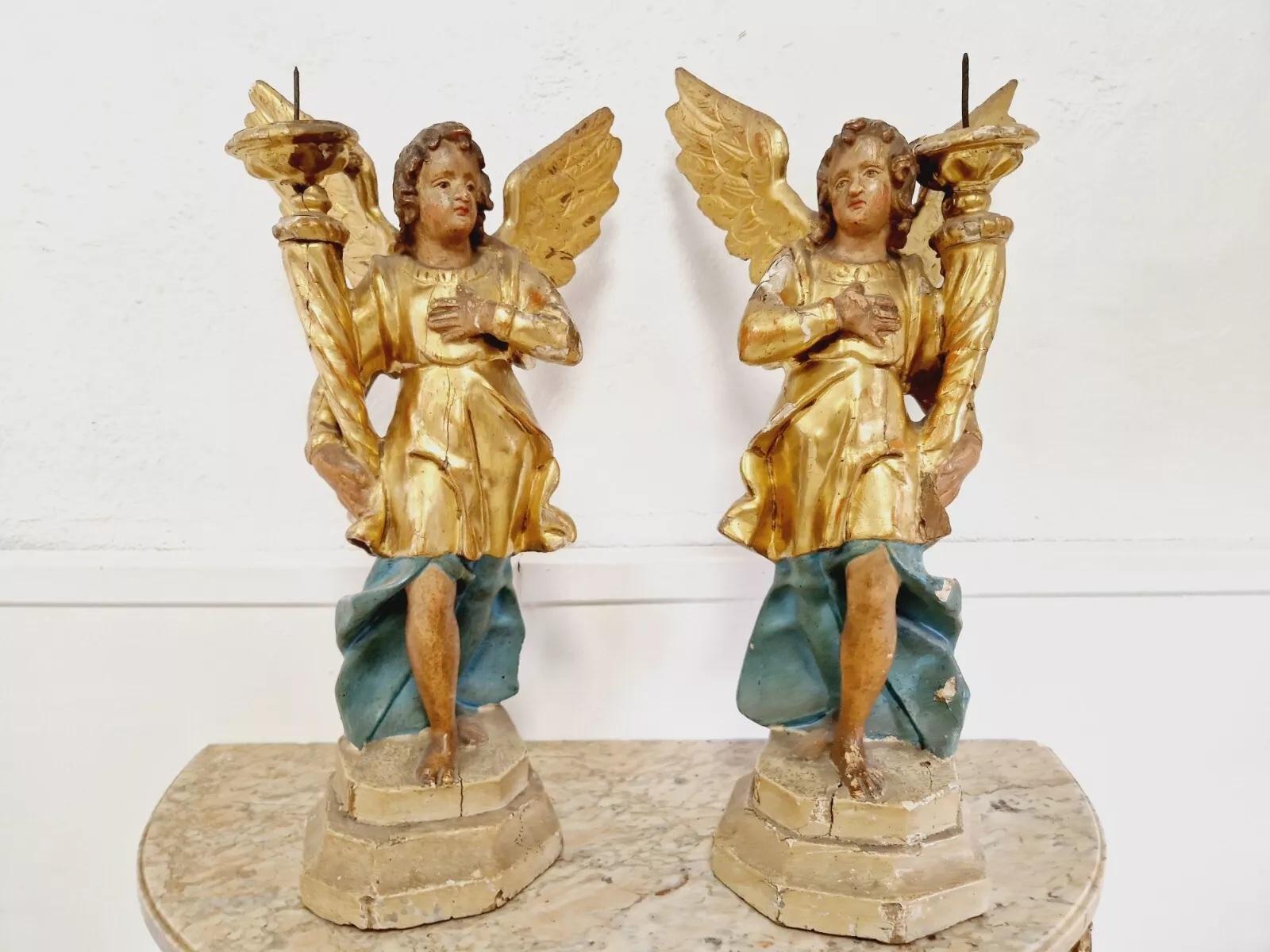 This pair of fabulous antique 18th century angel torch holders are a stunning addition to any art collection. Crafted from Gilded wood and featuring intricate carvings, these statues are a beautiful representation of the Baroque/Rococo period.