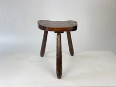 Vintage rustic brutalist carved wood tripod stool. France, c.1930-50