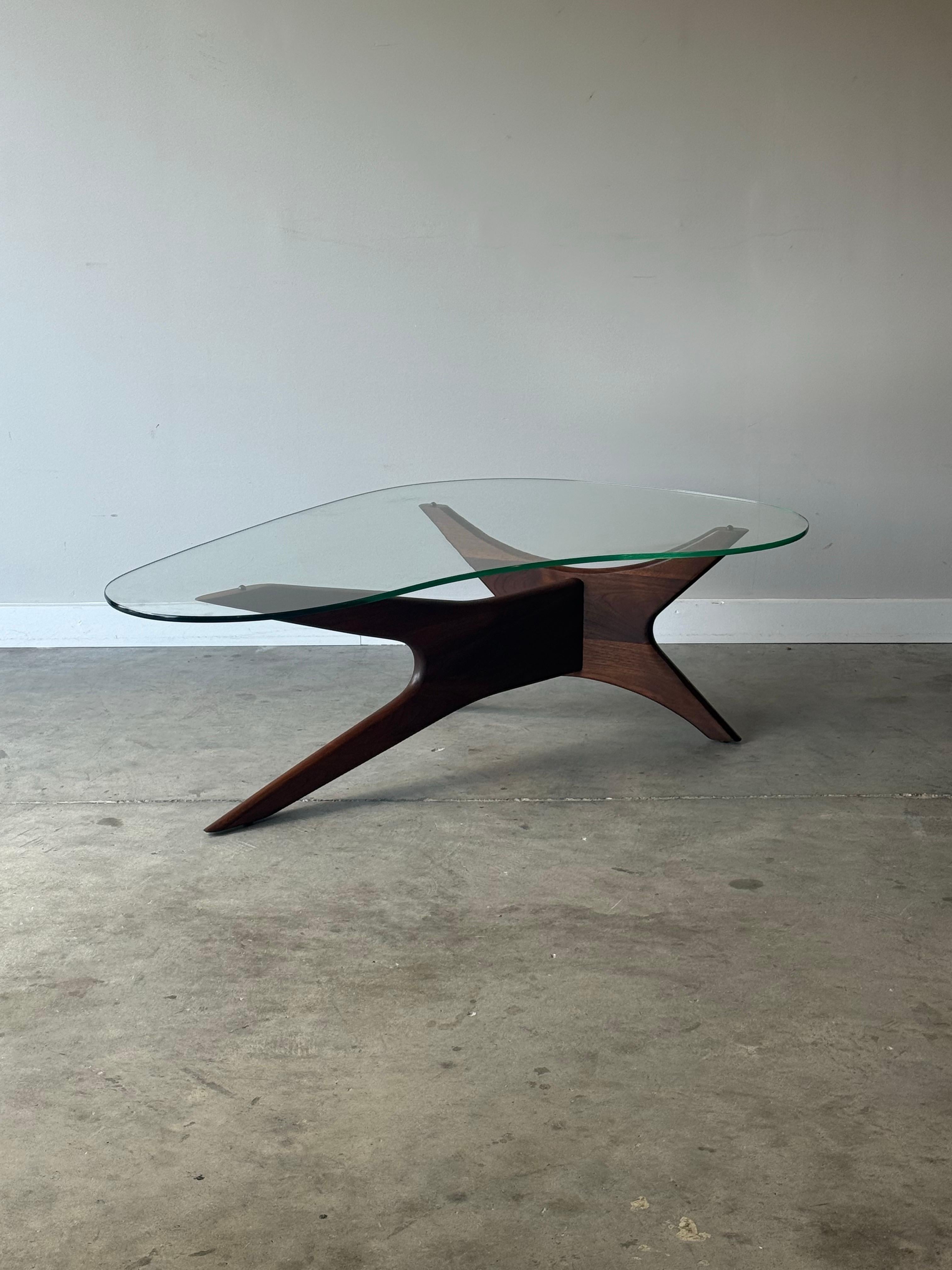 Mid century modern iconic walnut sculptural kidney shaped coffee table designed by Adrian Pearsall. Beautiful design with rich curvy walnut under a abstract thick cut rounded edge glass top. A perfect addition to any living room and timeless