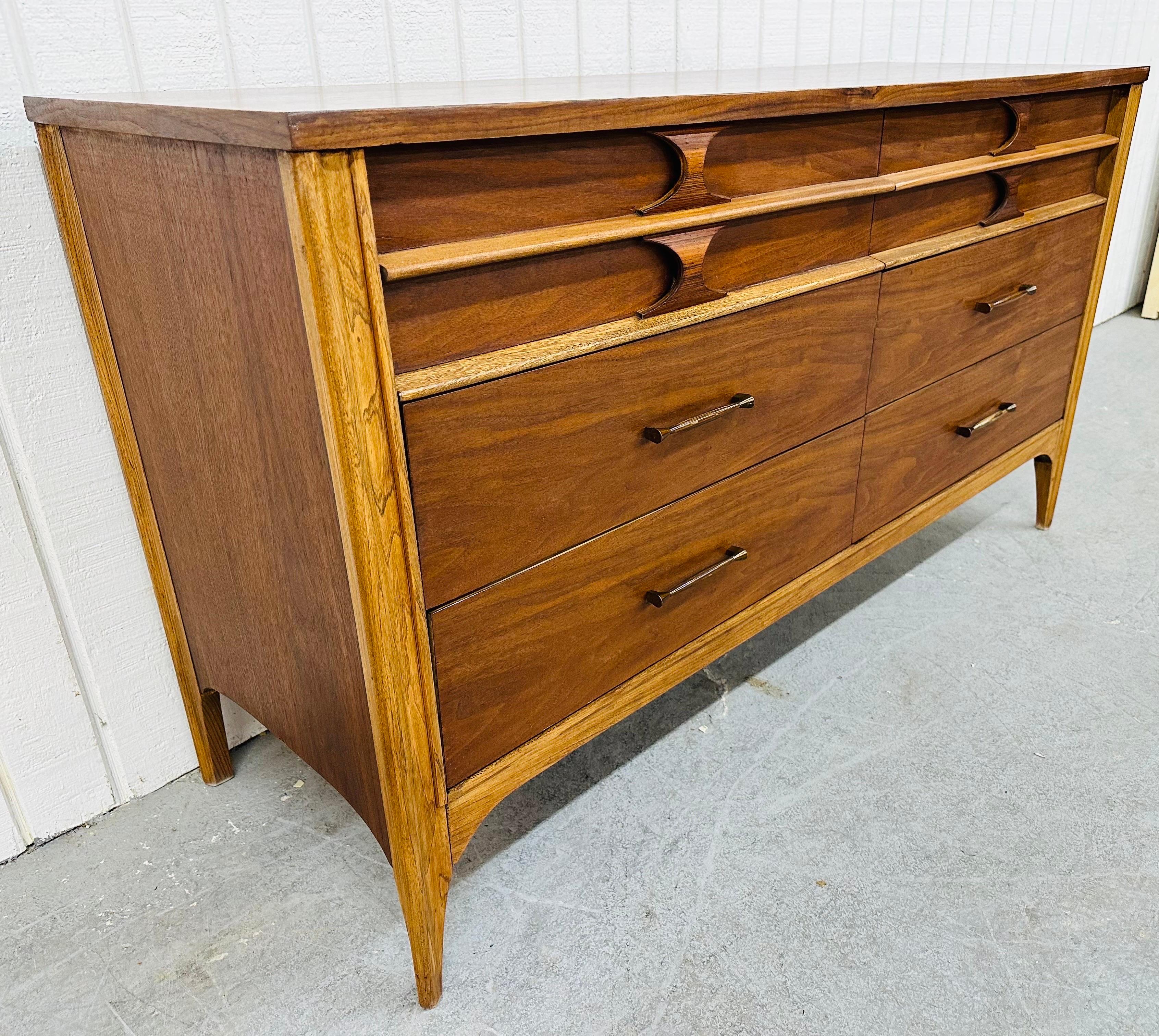 This listing is for a Mid-Century Modern Kent Coffey Perspecta Walnut Double Dresser. Featuring a straight line design, six drawers for storage, sculpted rosewood pulls at the top, original hardware on the bottom, modern legs, and a beautiful walnut