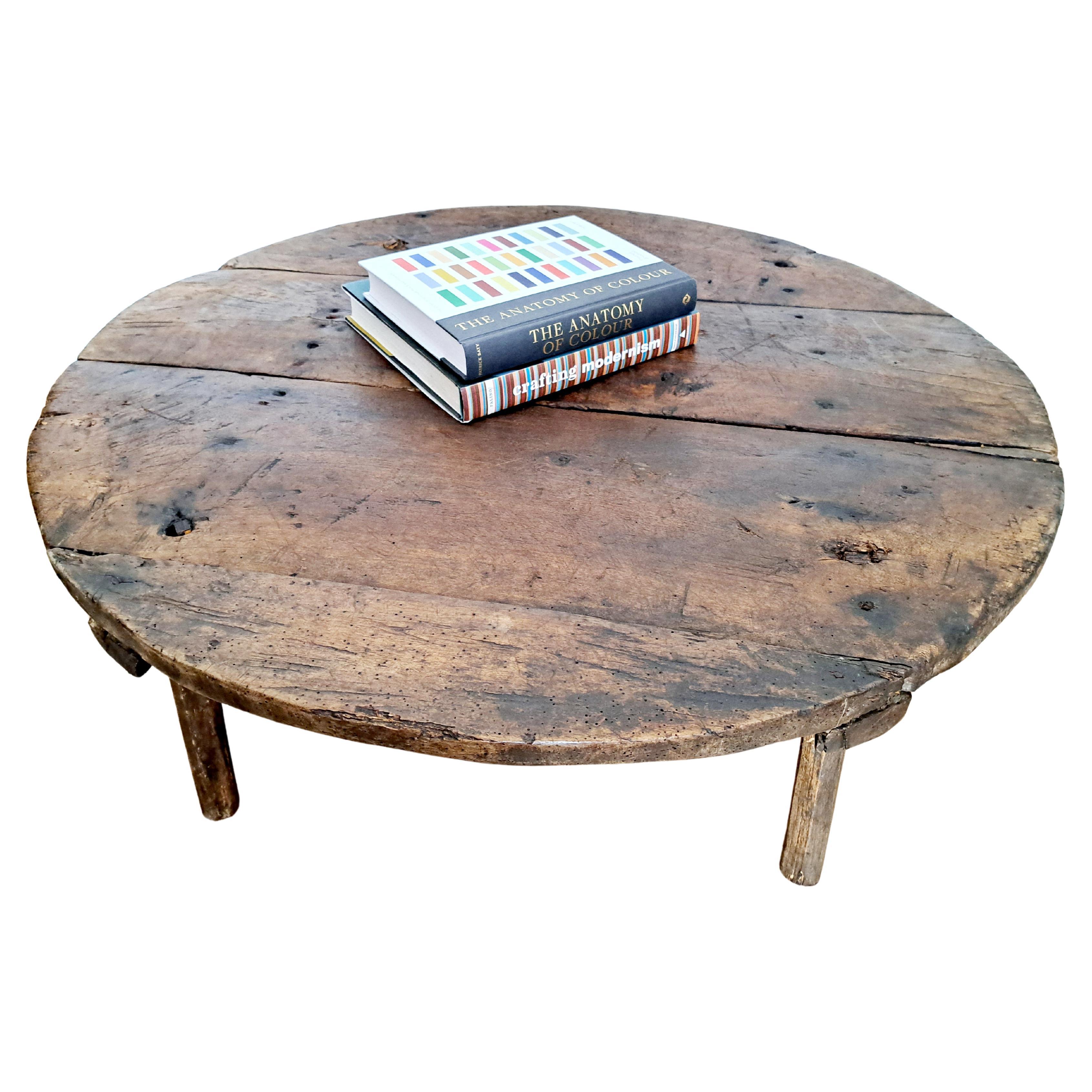 19th-century pine wooden coffee table, stitched with either wood or iron. Heavily patinated and full of character - functioning as a unique coffee table. Celebrating the cracks and crevices and all the other marks that time and loving use have left