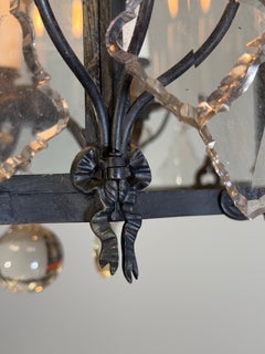 Louis XV-style lantern in blackened brass decorated with cut crystal pendants, a