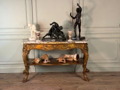 Console en bois doré, quatre pieds ornés de monstres marins, marbre brèche violet